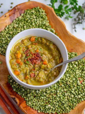 bowl of split pea soup on tray with dried split peas