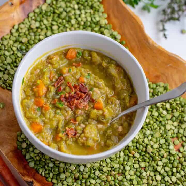 bowl of split pea soup on tray with dried split peas