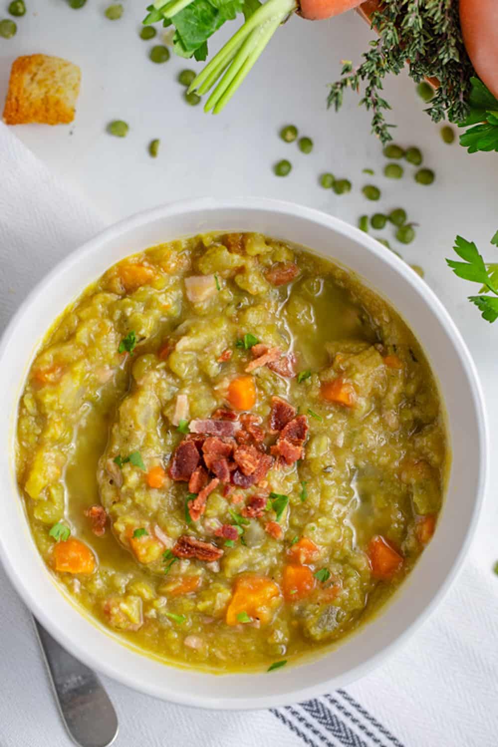 bowl of split pea soup garnished with bacon