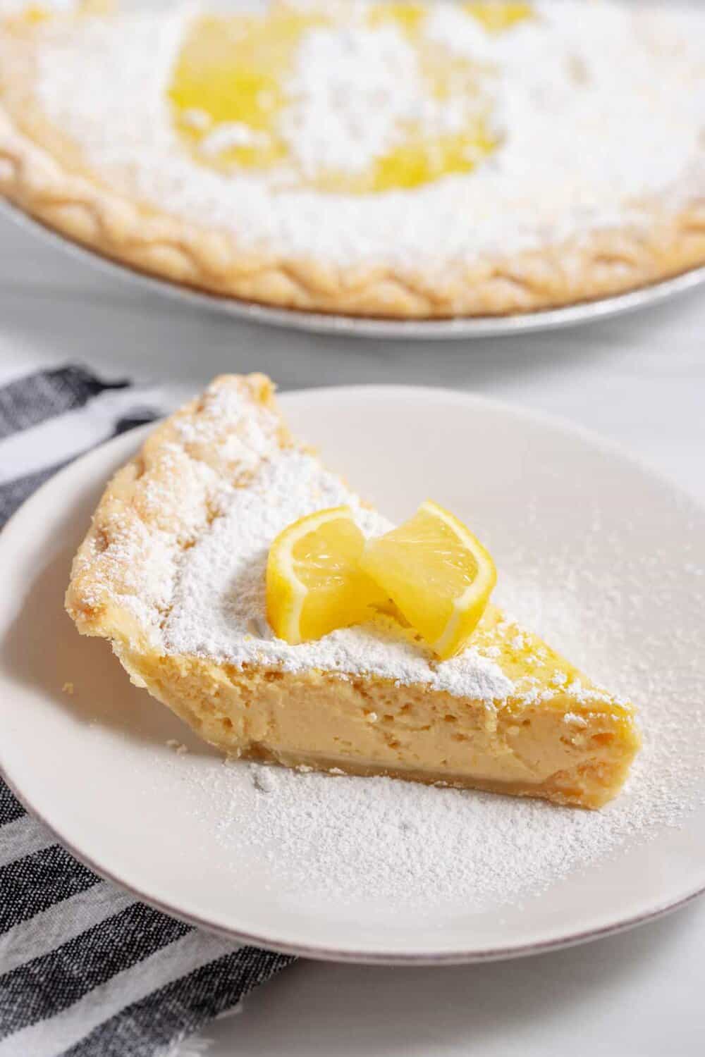 slice of Arizona lemon pie with powdered sugar and sliced lemon