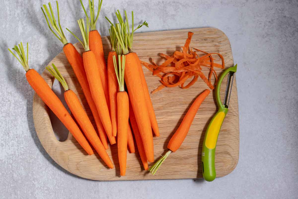 peeled carrots on a cutting board