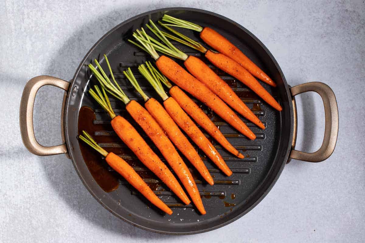 carrots coated with brown sugar glaze in roasting pan