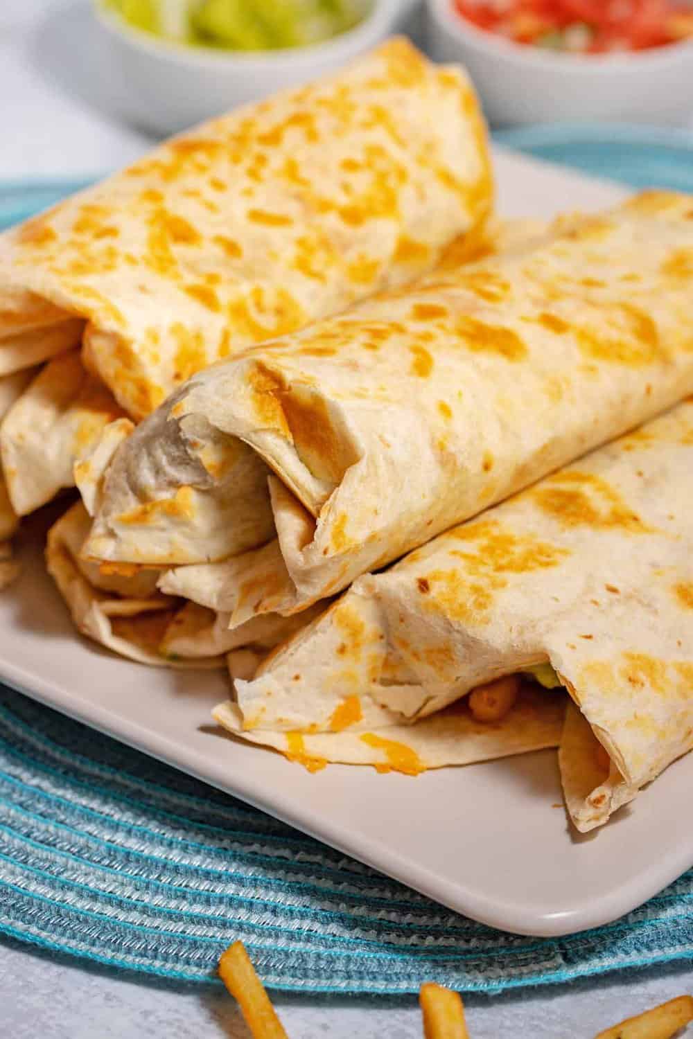 side view of California burritos on a platter