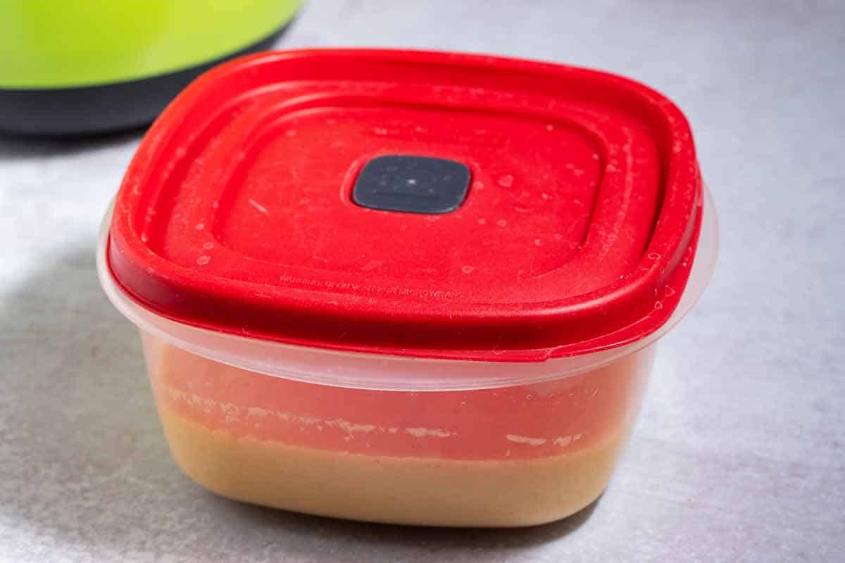 Freezing cake batter in a plastic storage container.