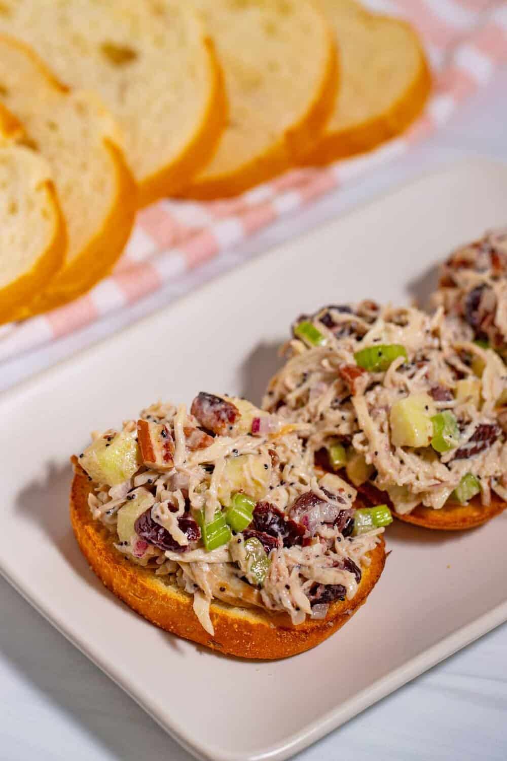 Open chicken salad sandwich on French bread slices.