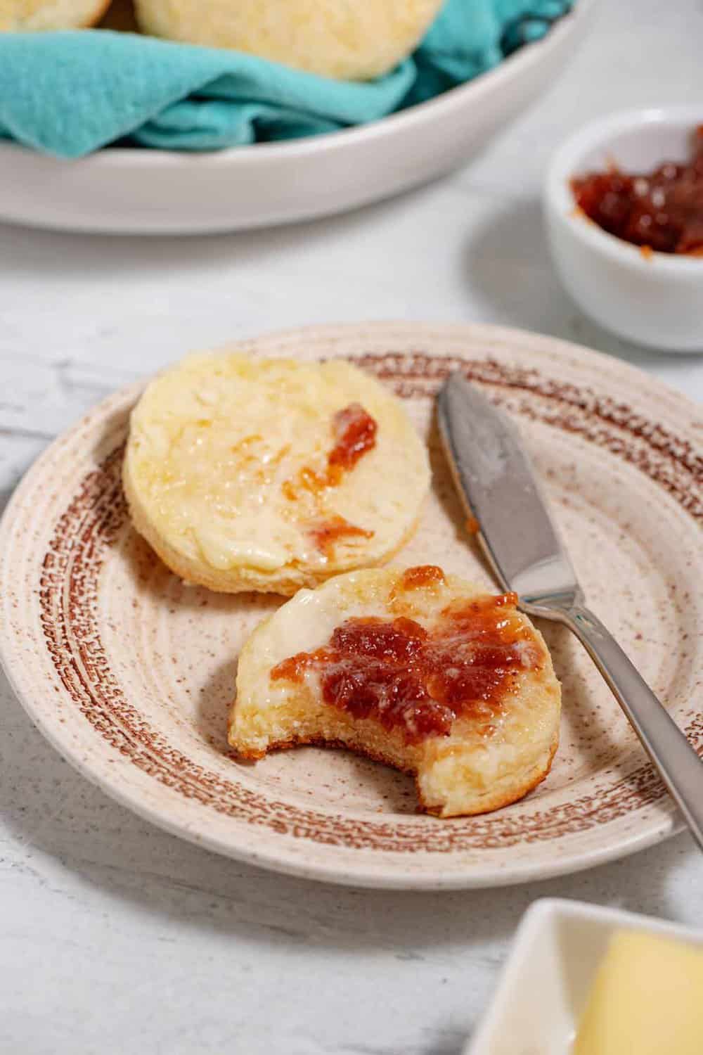 plate of buttermilk biscuits with butter and jam