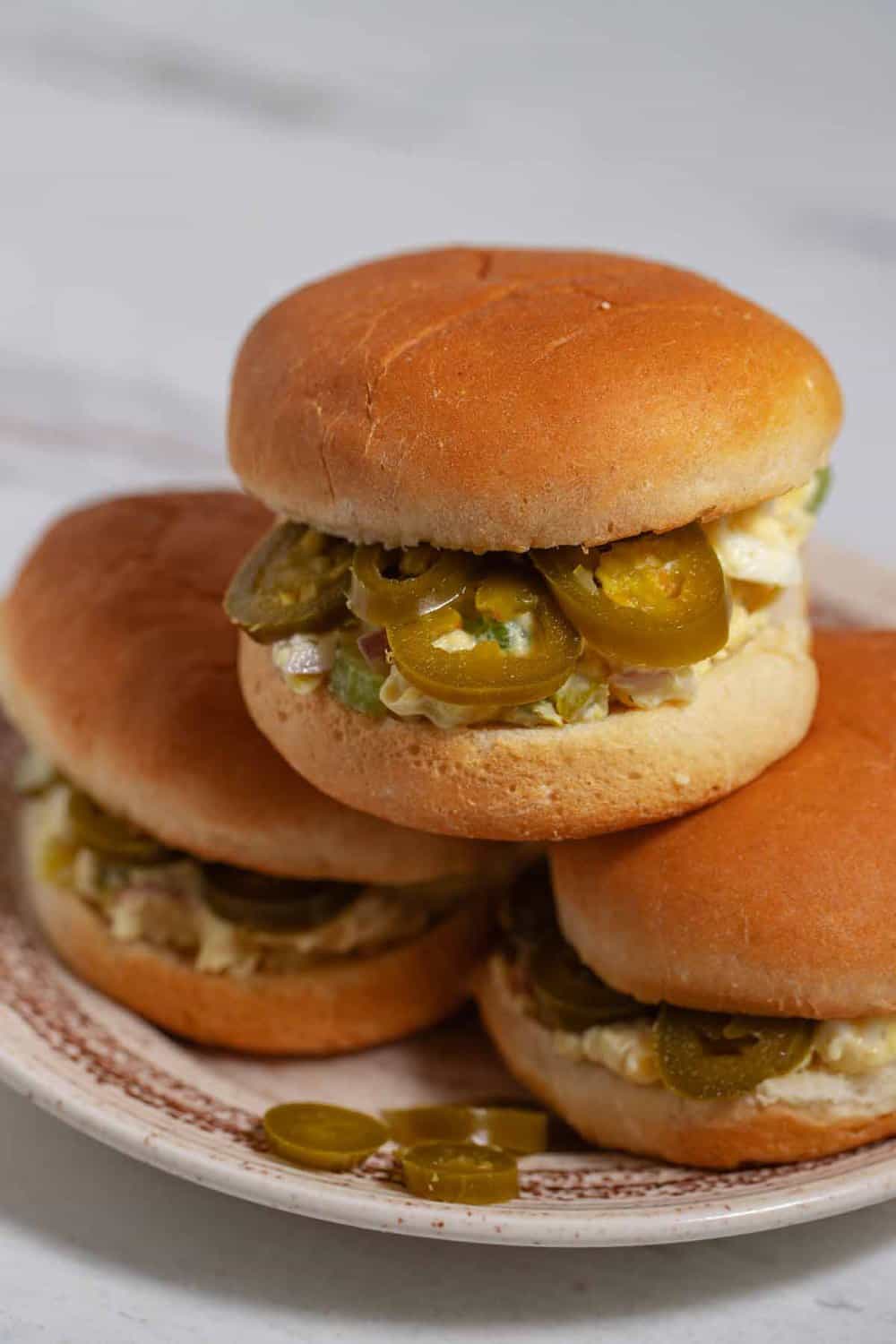 pickled jalapenos are a sandwich topping on chicken salad sandwiches on mini buns