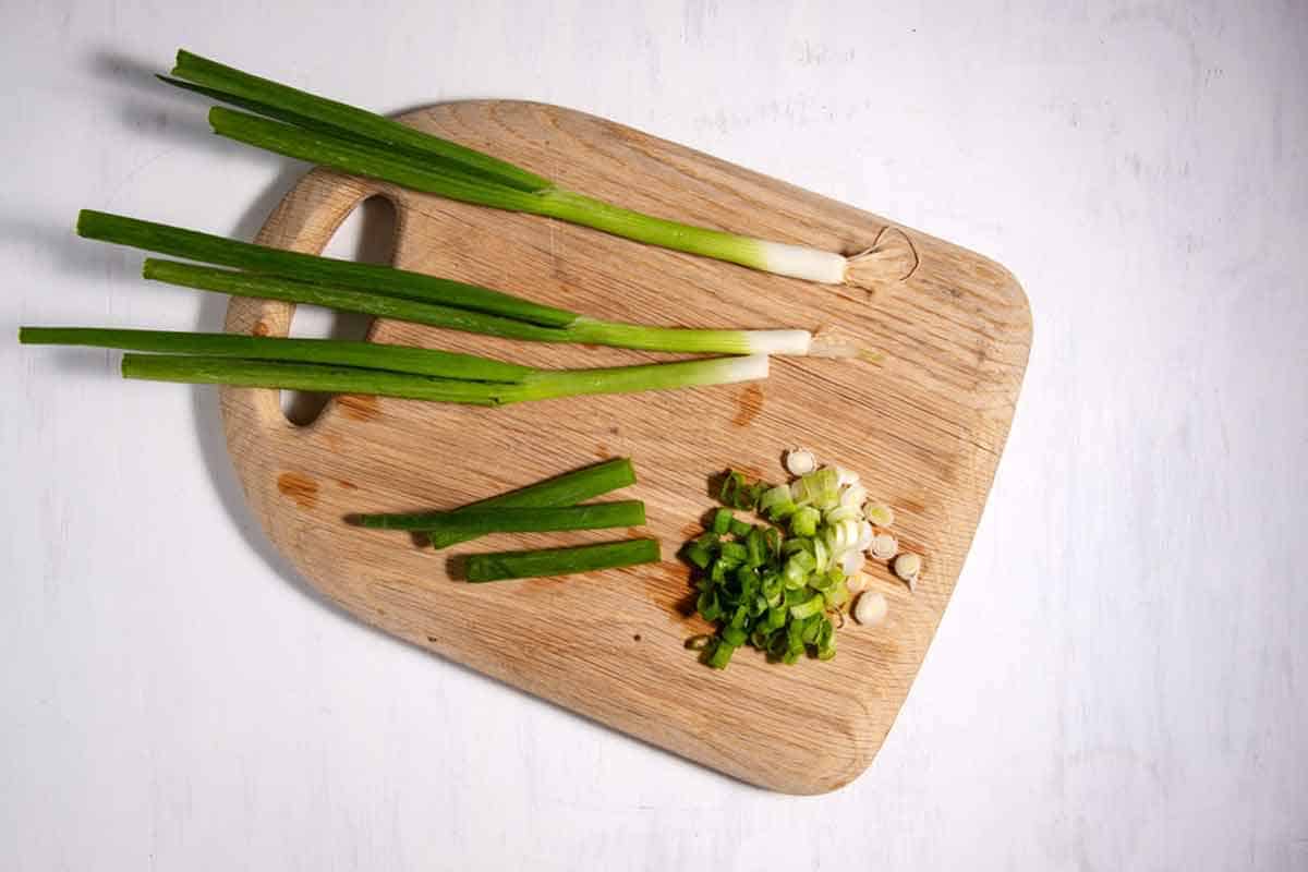 green onions on a cutting board