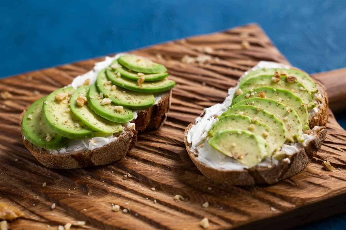 Avocado toast on a bread board.