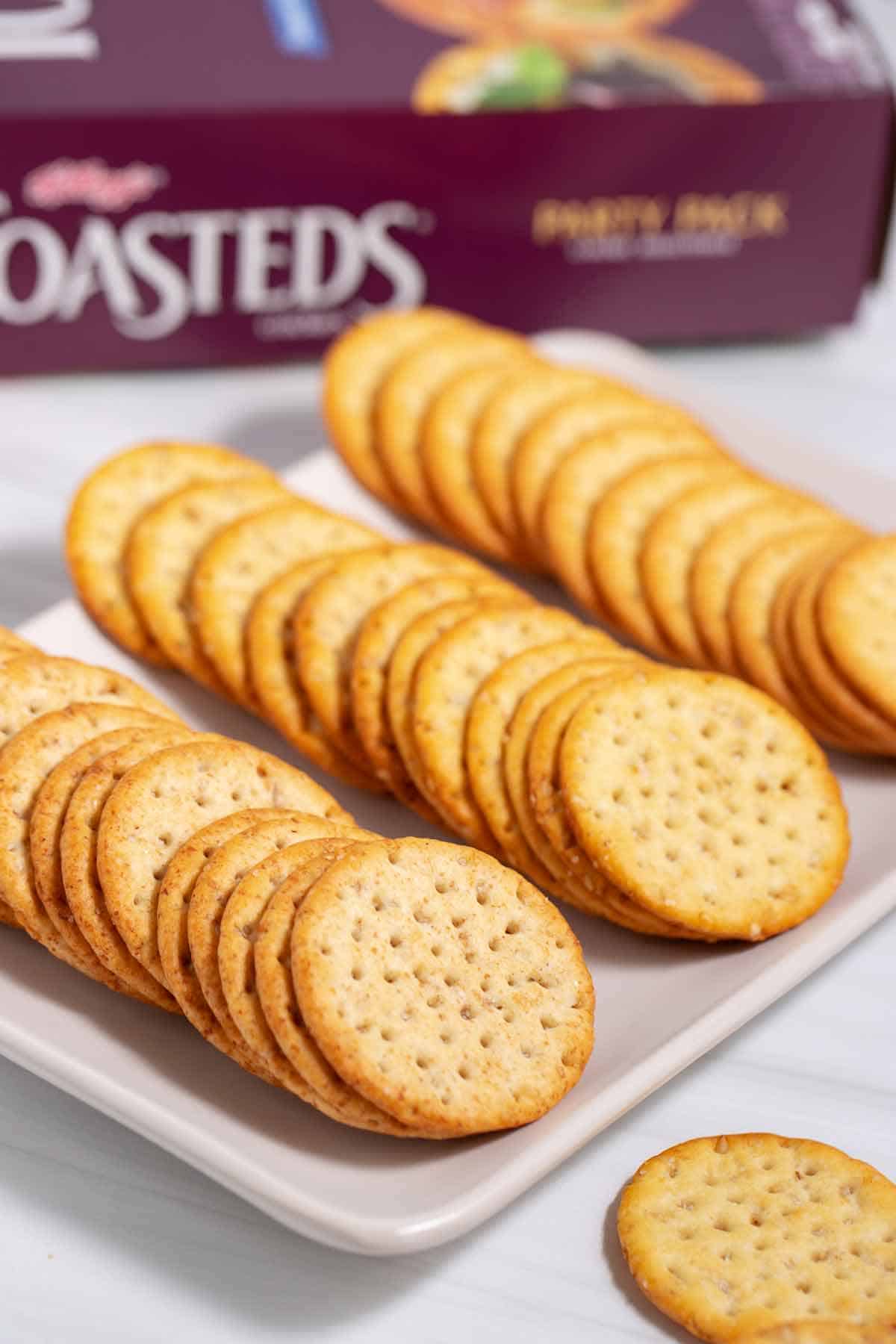 Plate of round appetizer crackers on a plate.