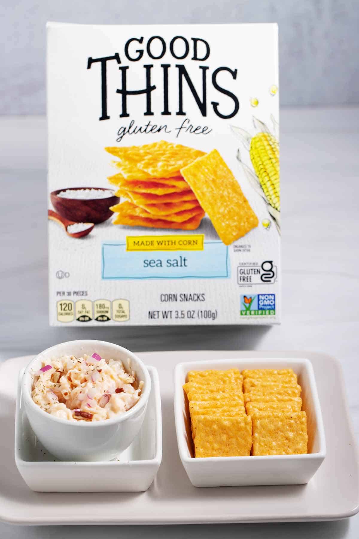 Good Thins corn crackers next to a bowl of chicken salad.