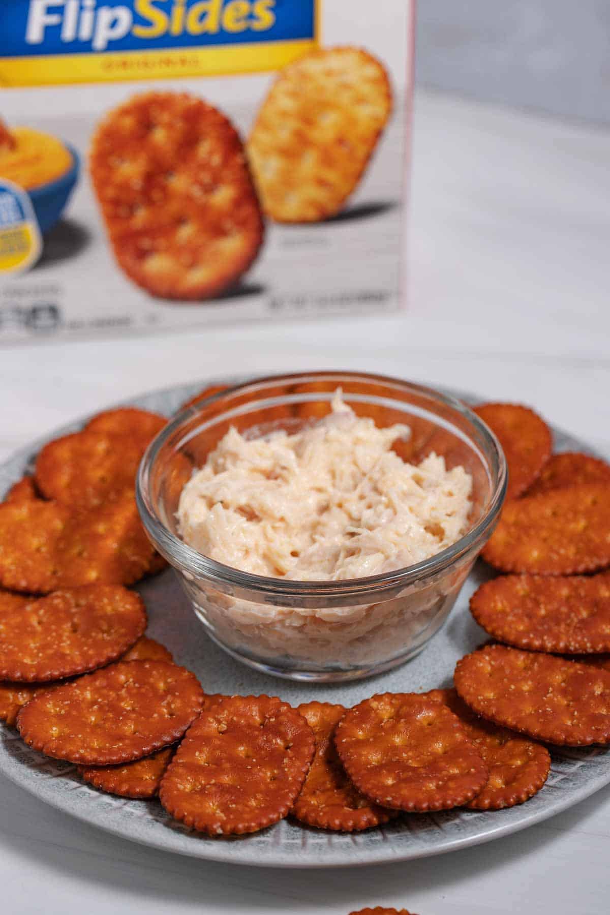 Plate of FlipSides crackers with a bowl of chicken salad in the middle.