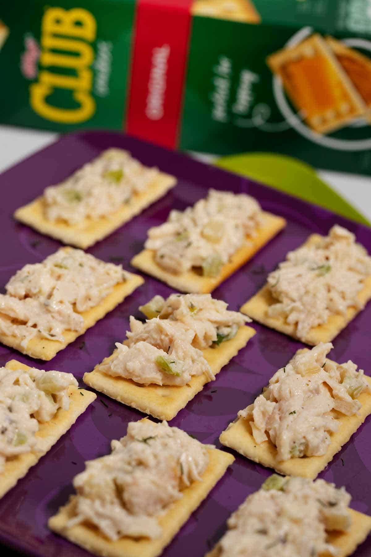 Club chicken salad cracker appetizers on a serving plate.