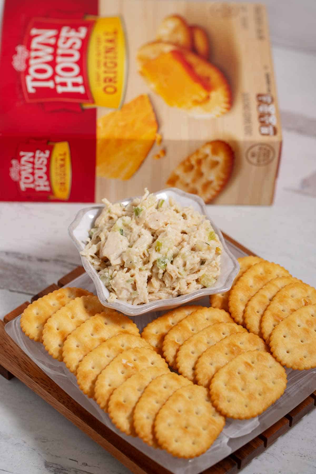 Town House original crackers on a plate with a bowl of chicken salad.