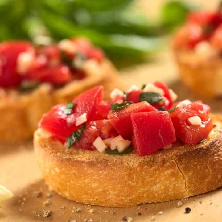 Tomato bruschetta on bread board.
