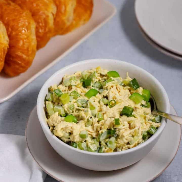 bowl of chicken salad for a crowd with croissants on a plate