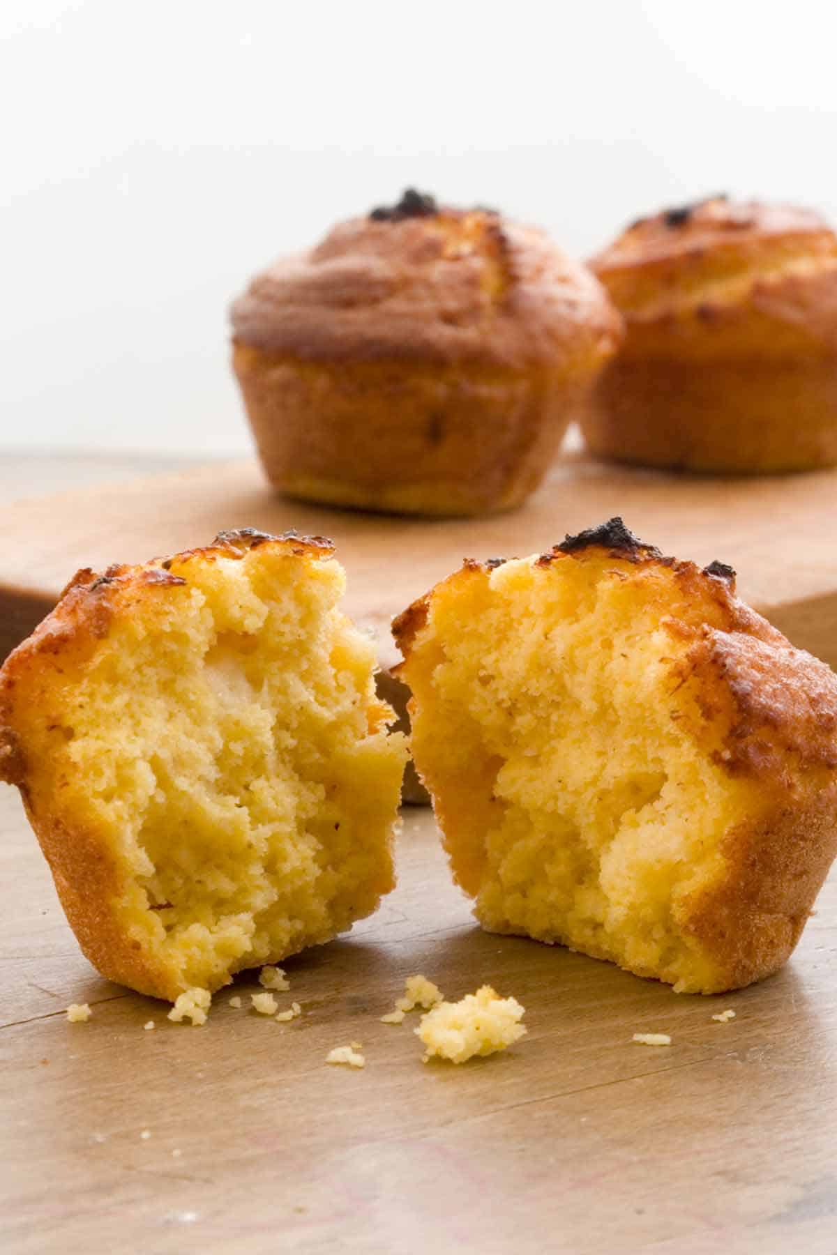 Cornbread muffins with one cut in half.