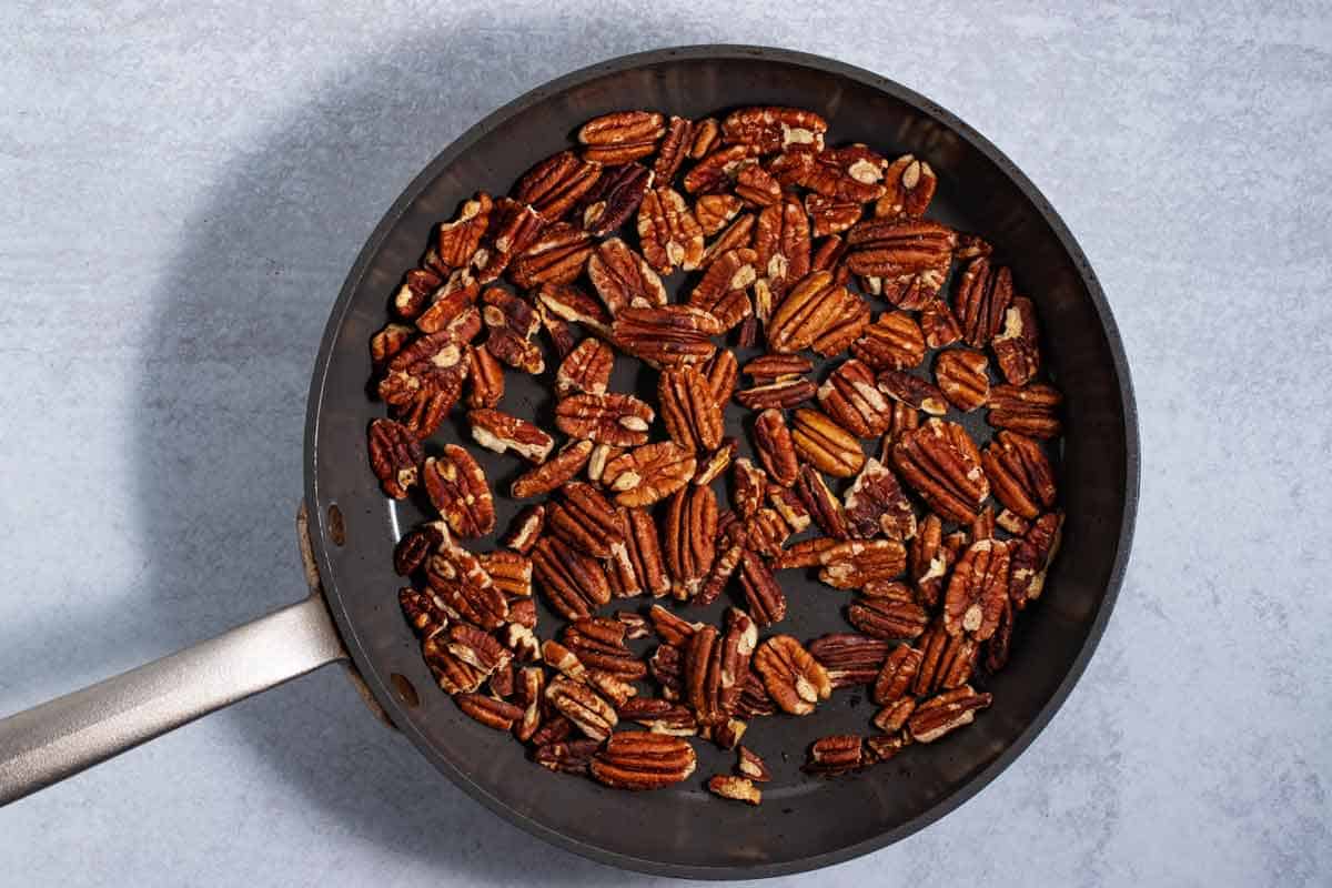 Pecans toasting in a skillet.