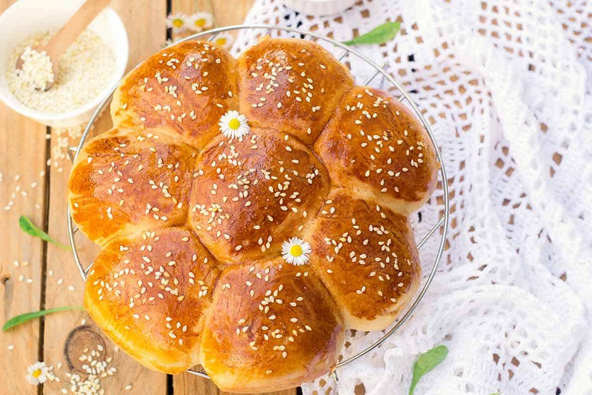 Homemade Hawaiian rolls on a cooling rack.