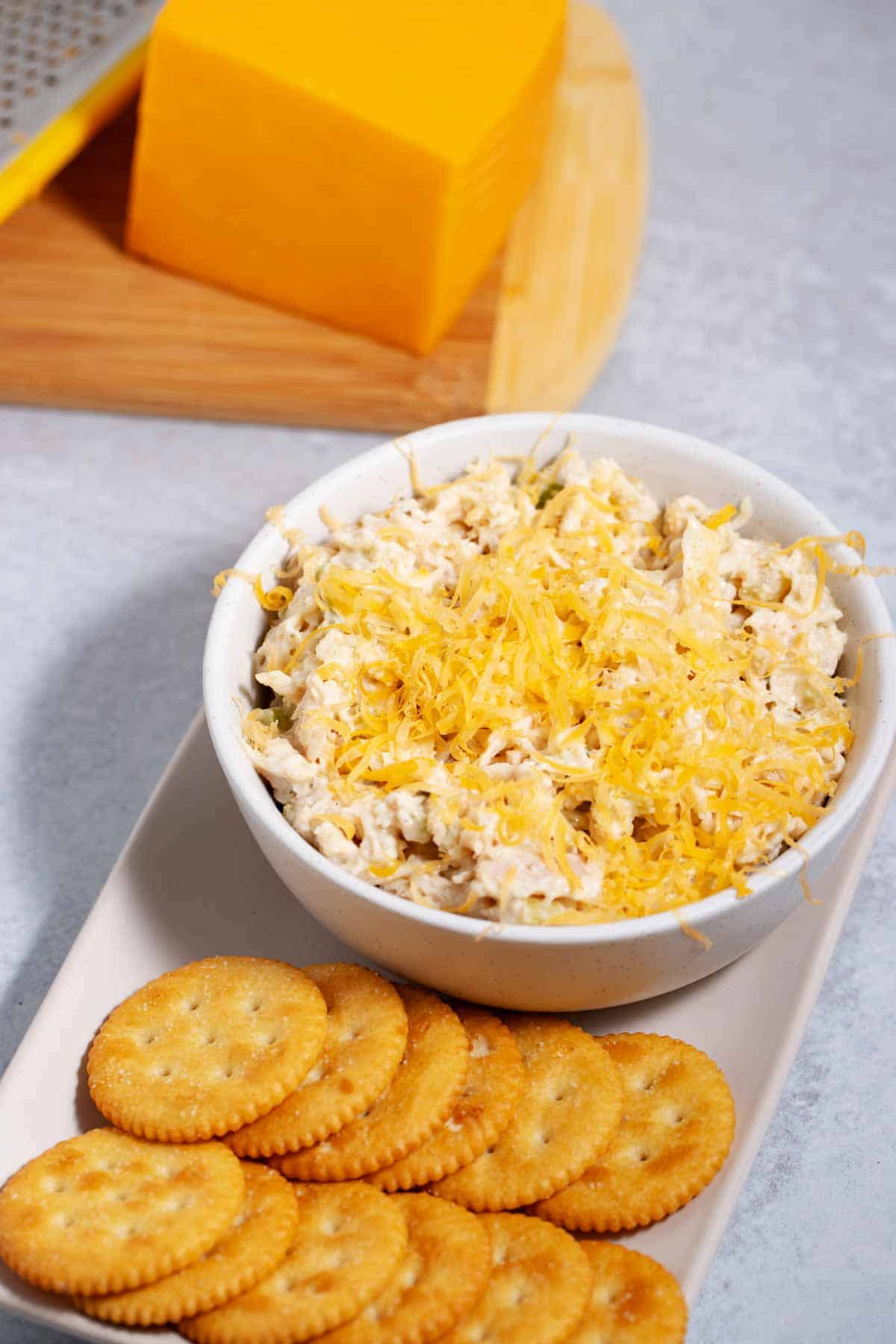 Shredded cheese added to store-bought chicken salad to make it better.