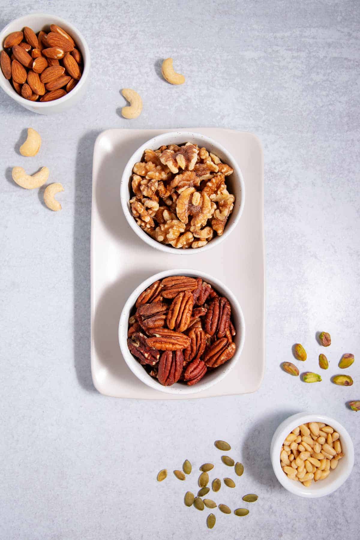 A variety of nuts in bowls.