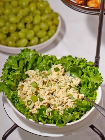 Store-bought chicken salad with ingredients added in a lettuce bowl.