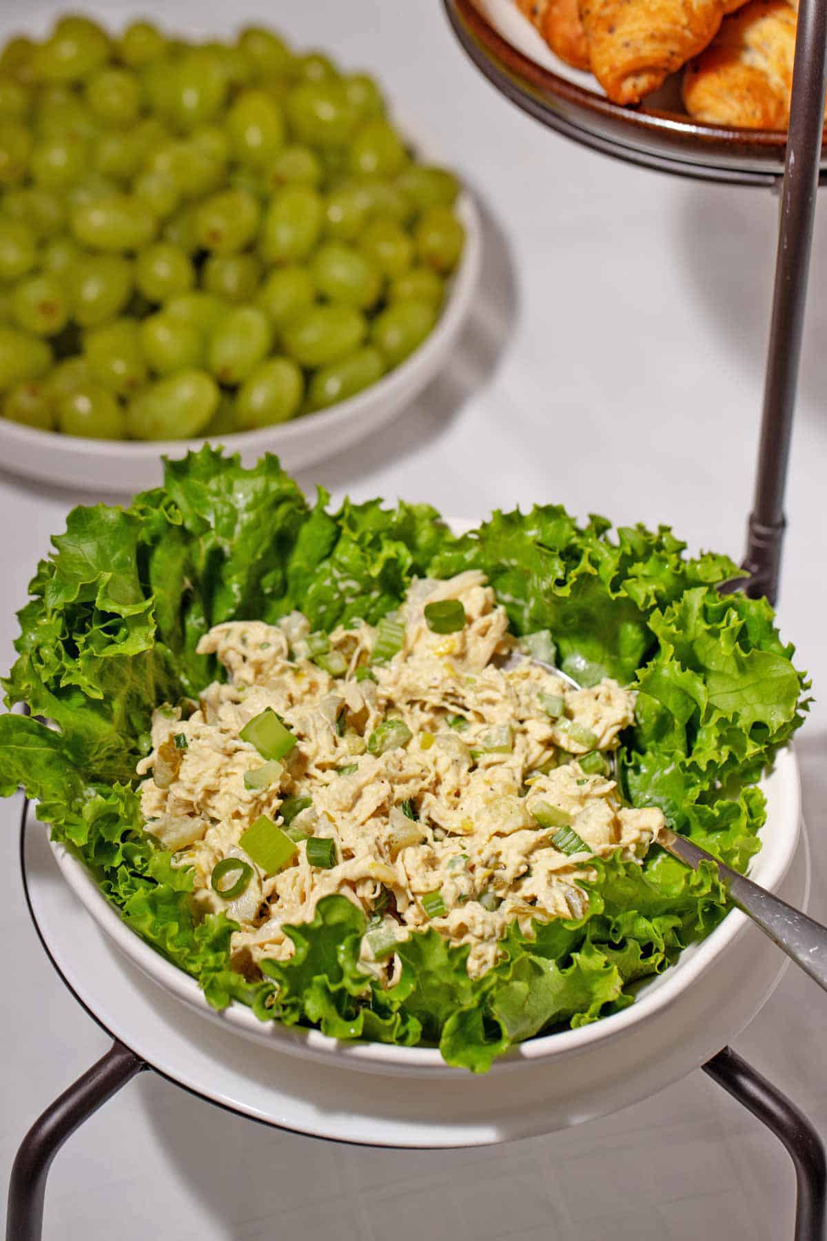 Store-bought chicken salad with ingredients added in a lettuce bowl.