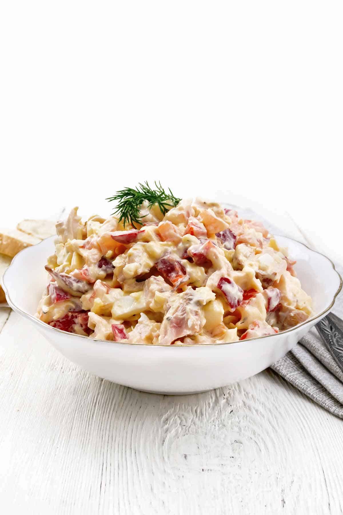 Bowl of chicken salad with a white background.
