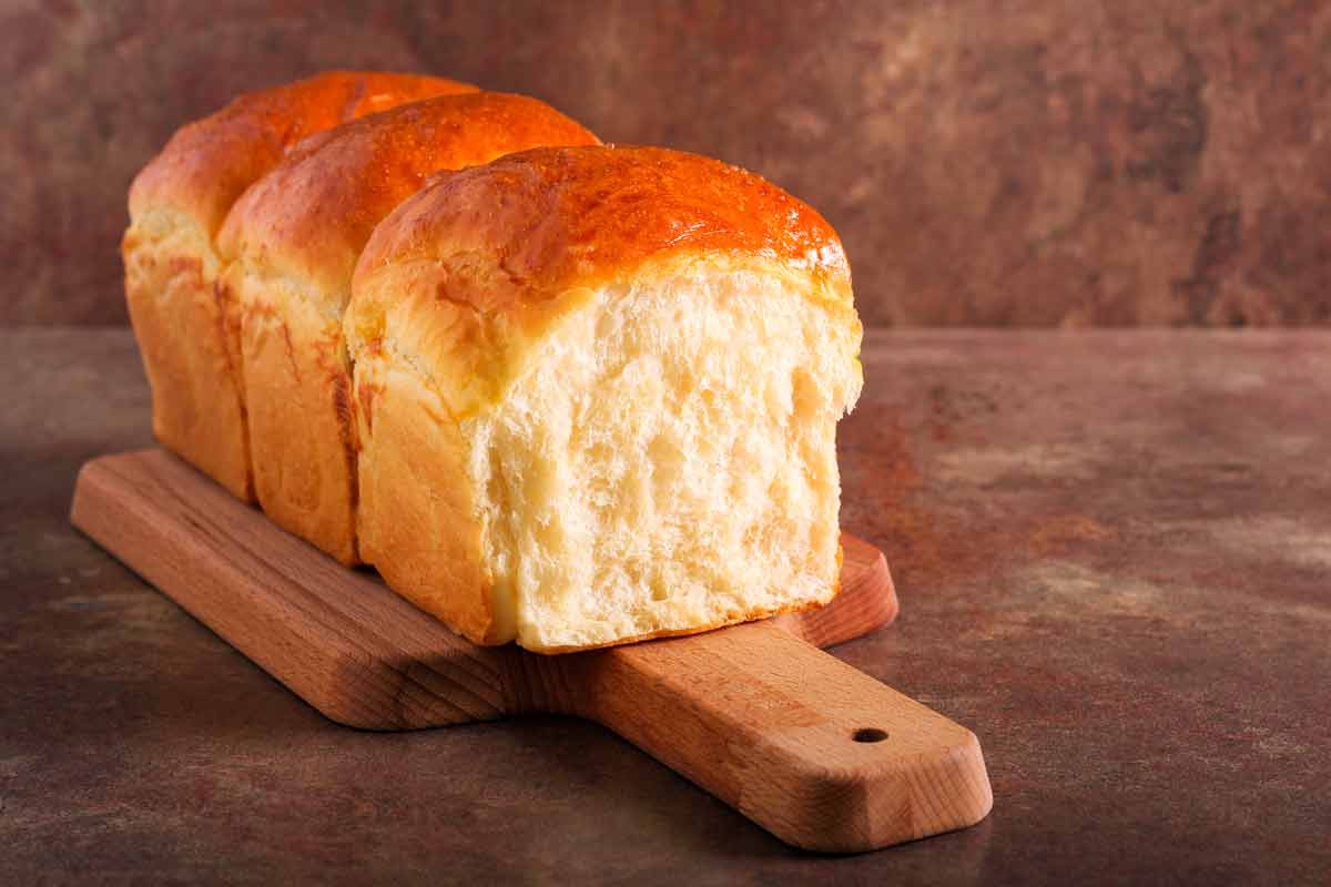 Loaf of Japanese milk bread on a cutting board.