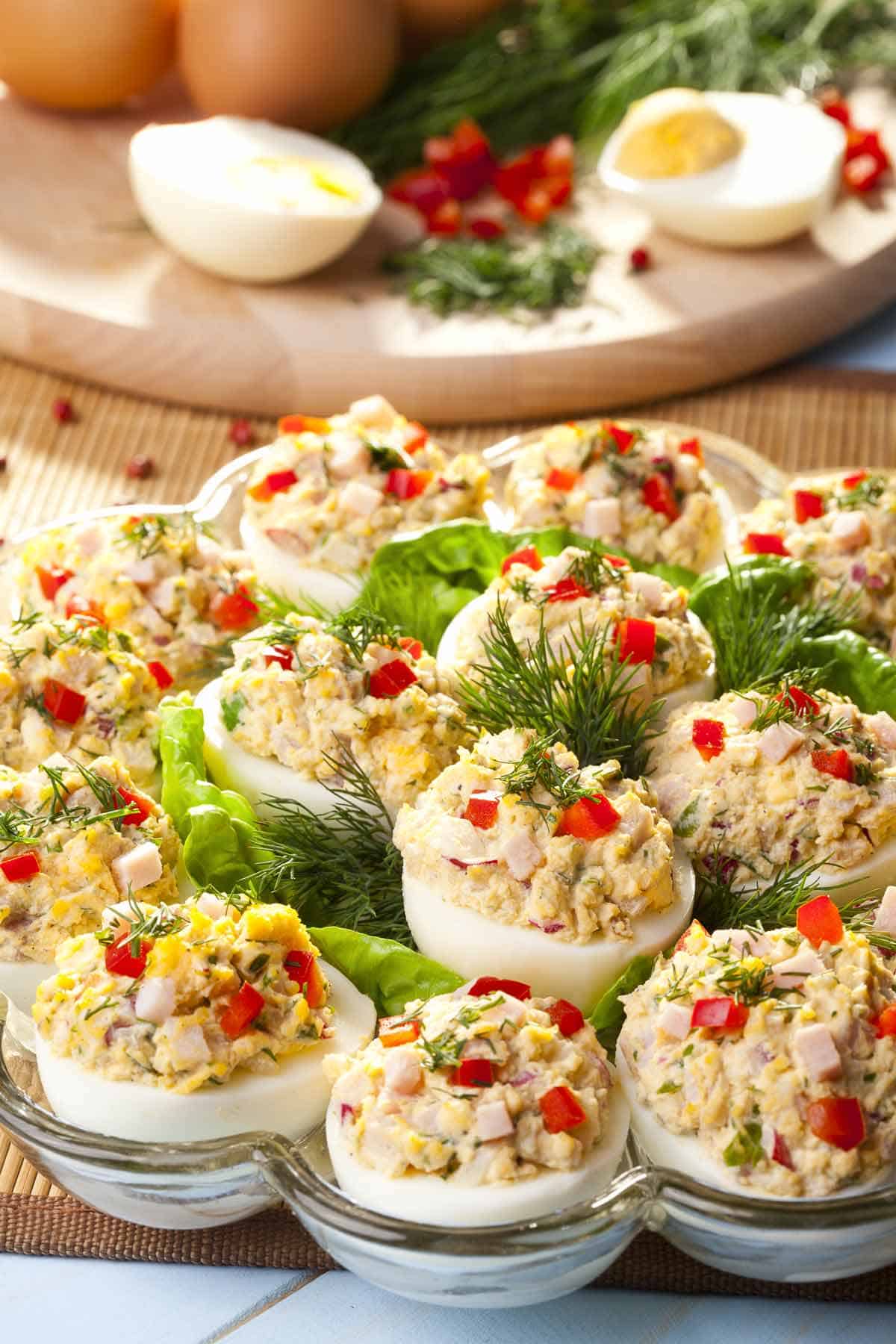 Chicken salad deviled eggs in a serving dish.