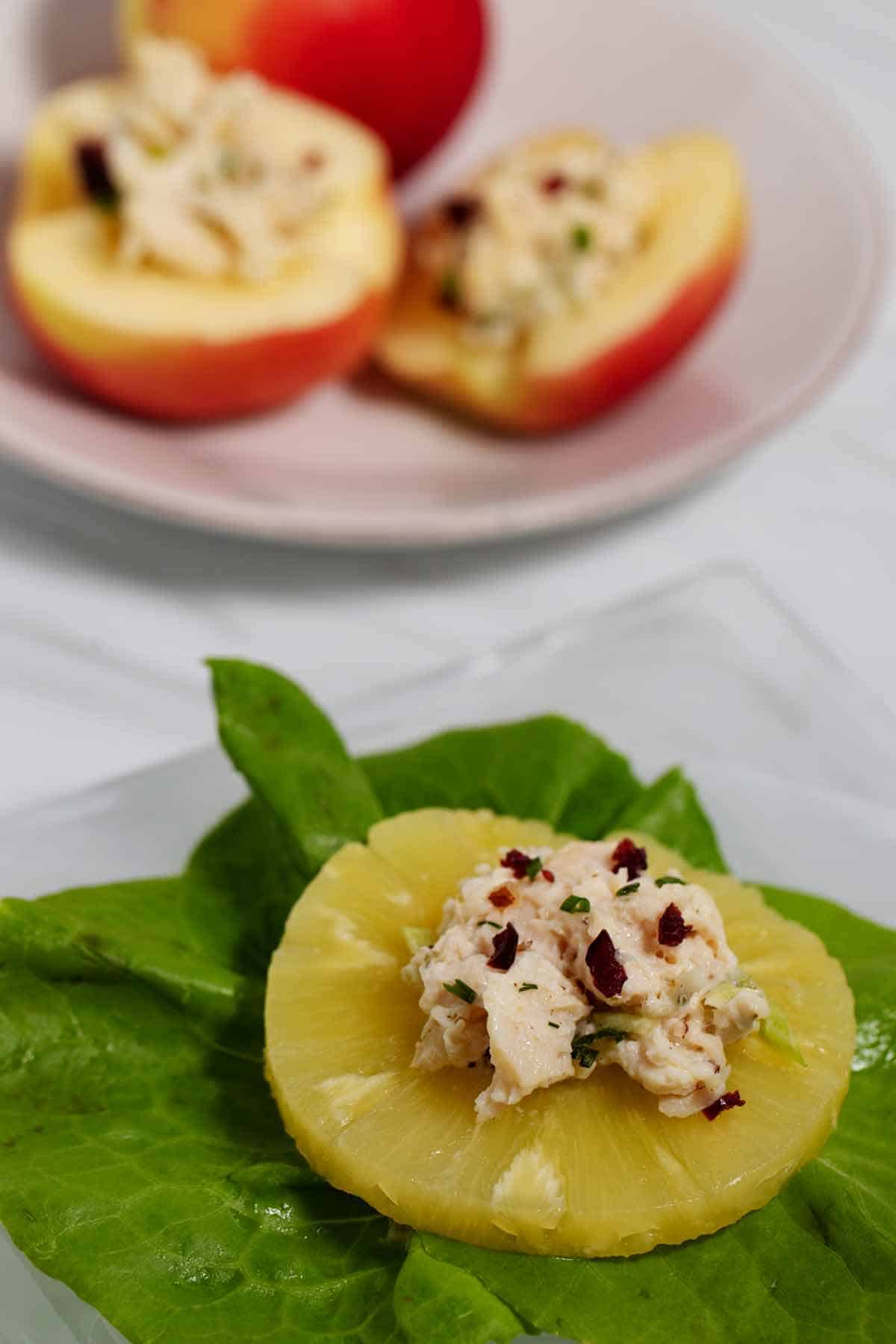 Chicken salad in a pinepple ring with stuffed apples in the back.