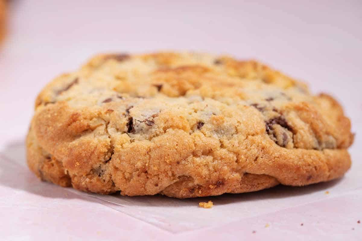 Close-up side view of a thick bakery-style cookie.