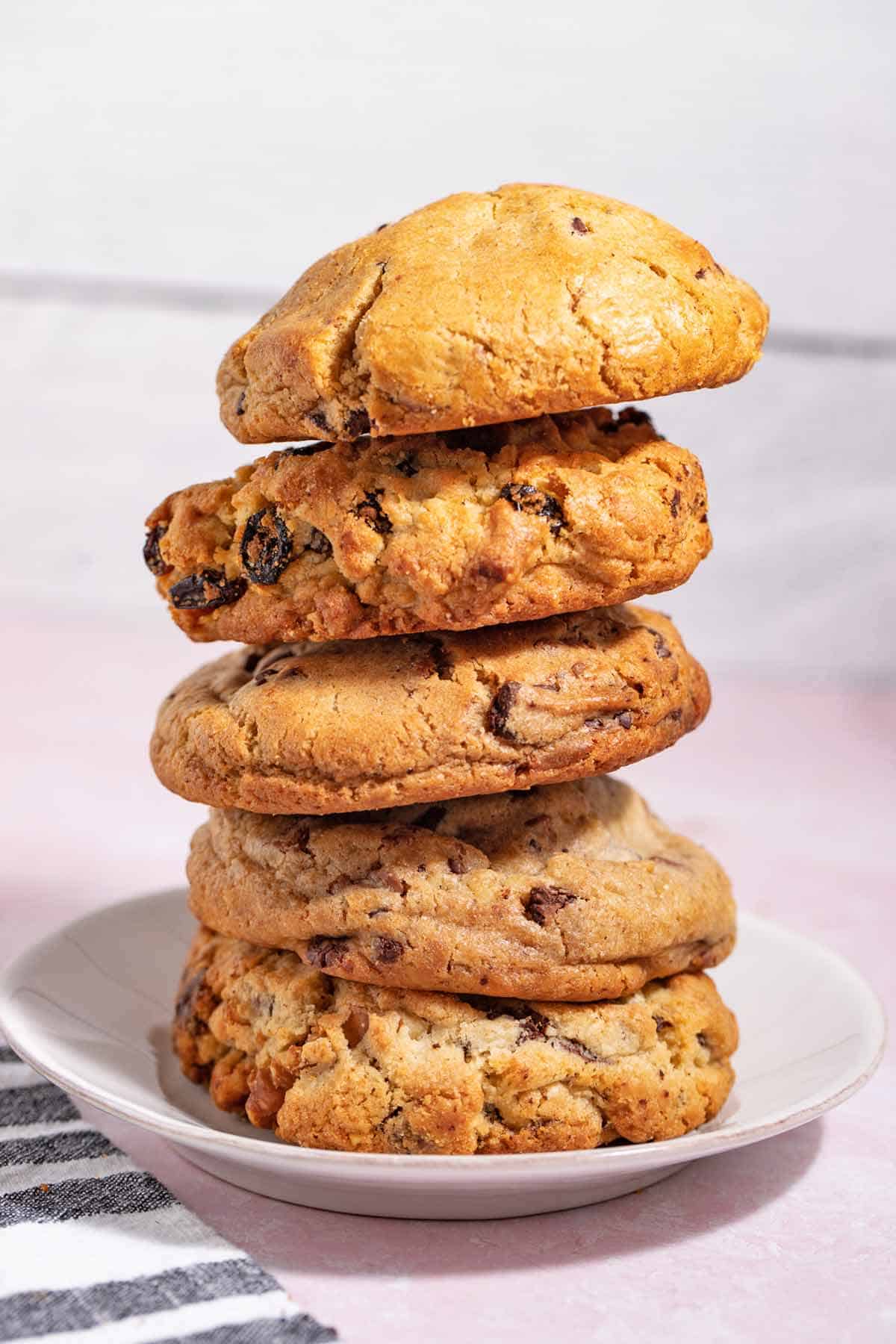 Tall stack of bakery-style cookies on a plate.