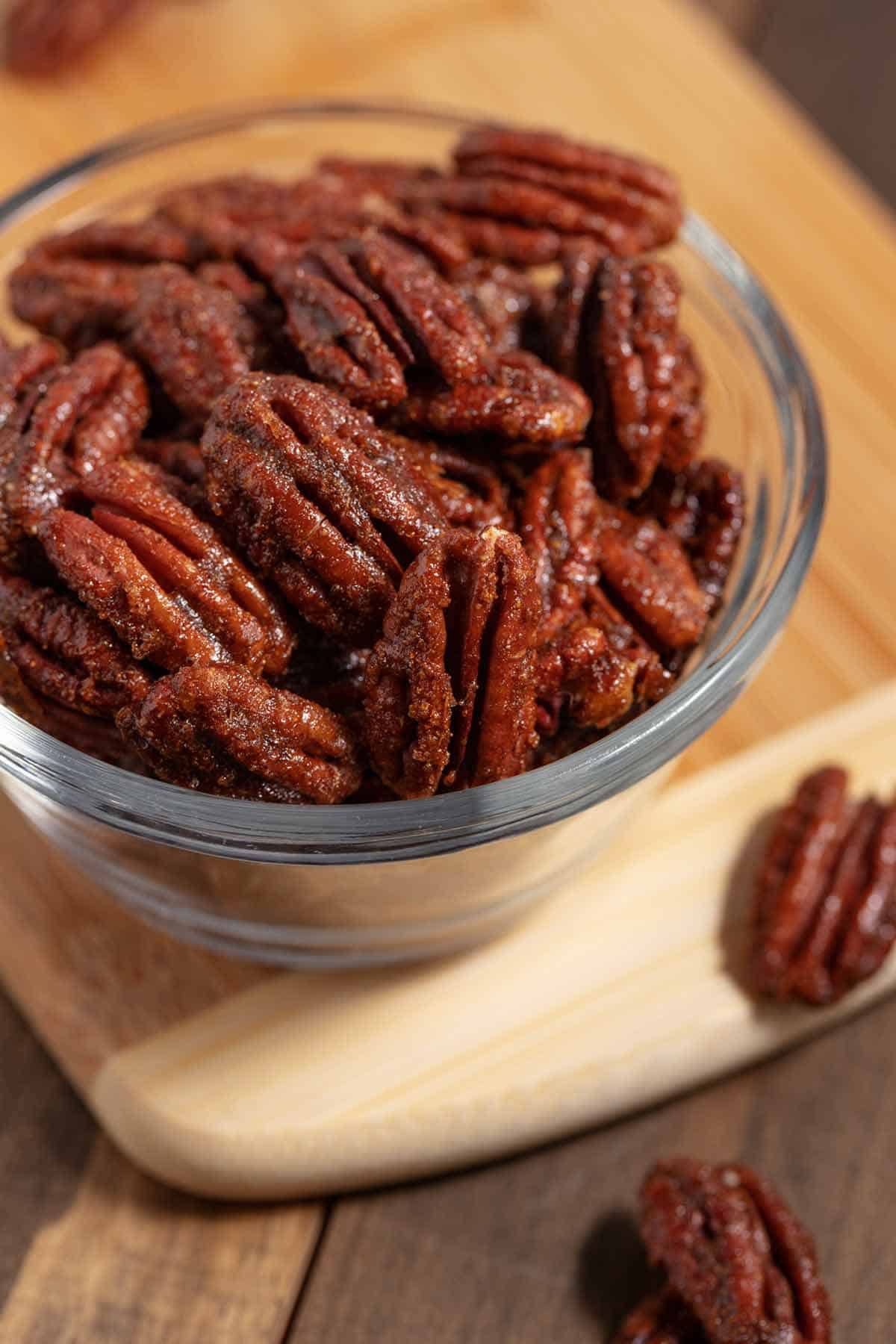 Small bowl of candied Trader Joe's copycat sweet and spicy pecans.