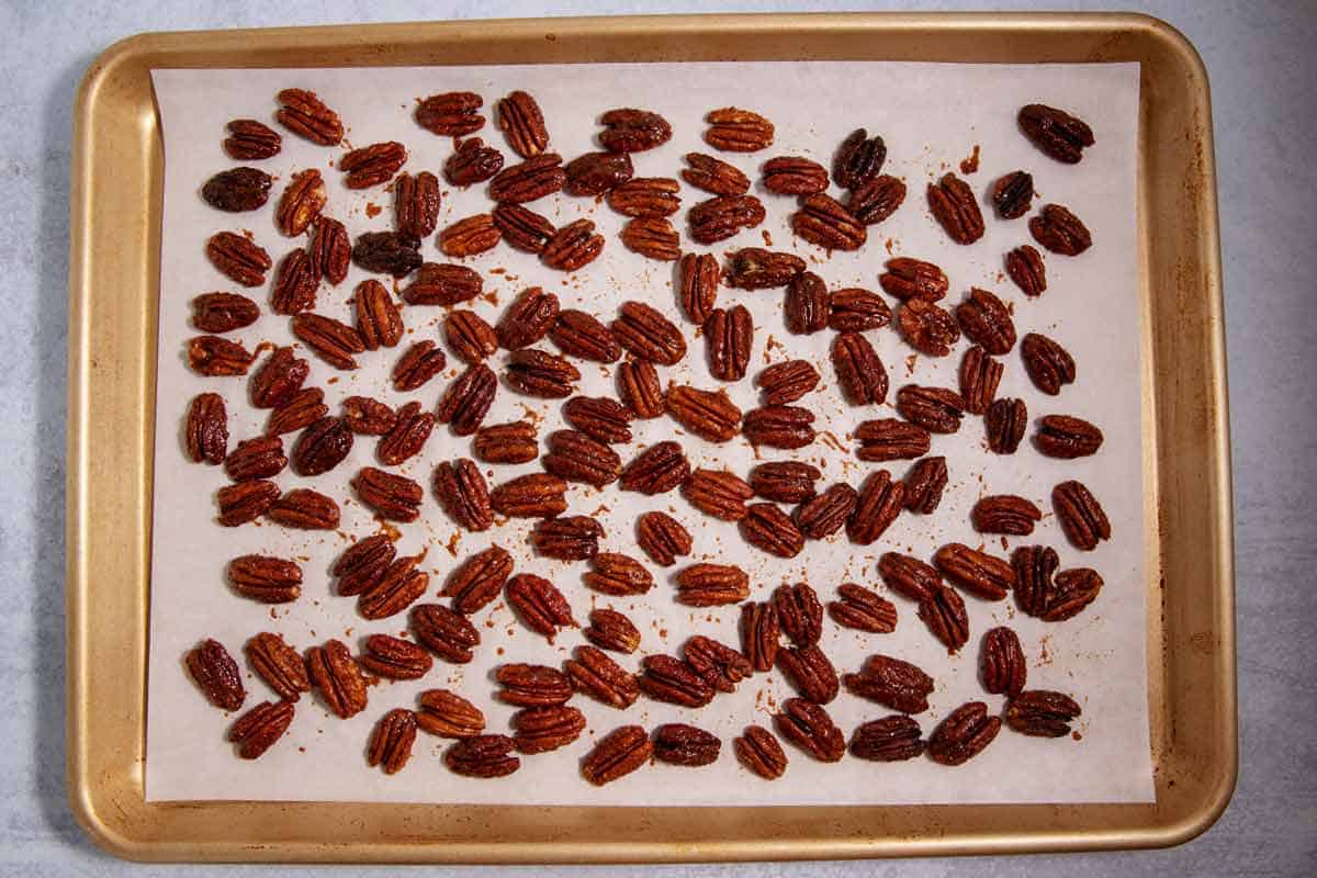 Baked sweet and spicy candied pecans on a baking sheet.