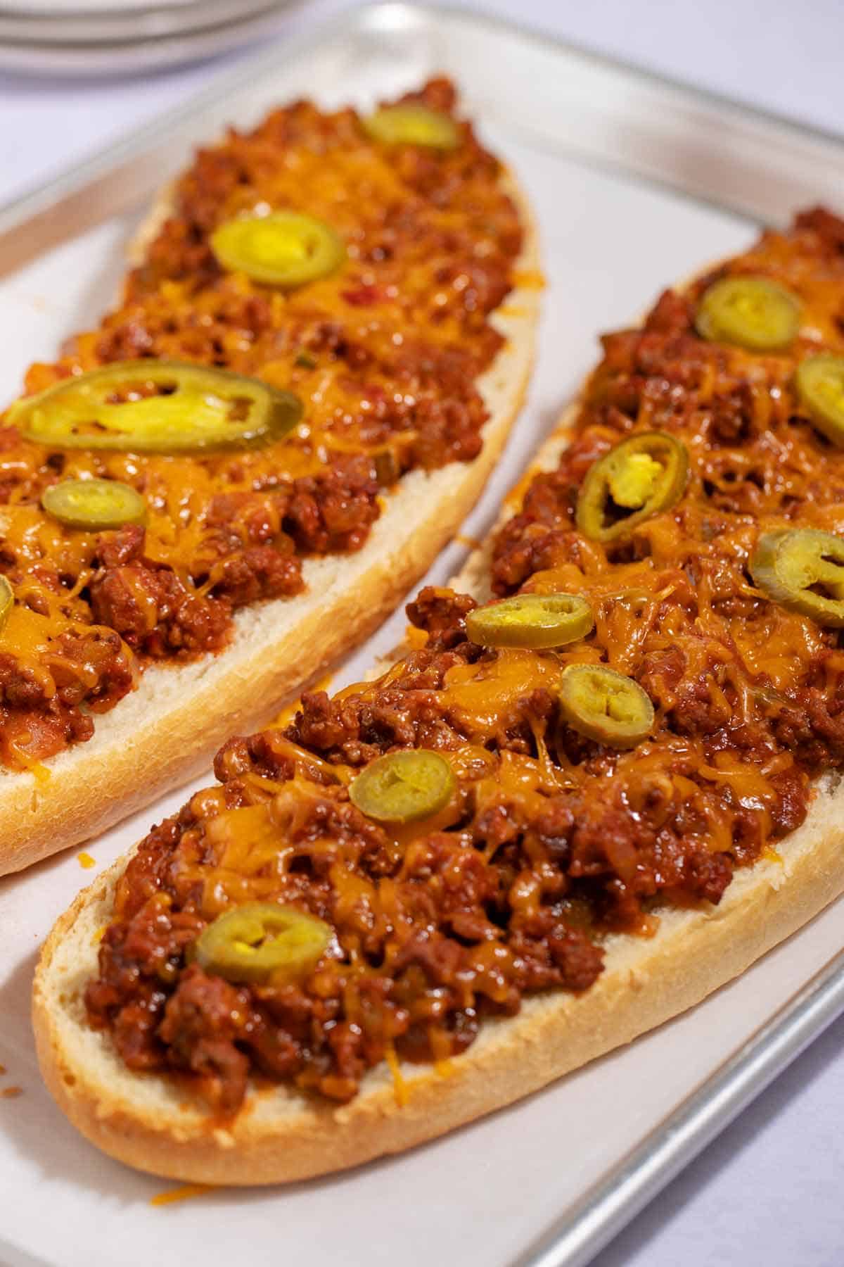 Baked sloppy joes with cheese on a French loaf.