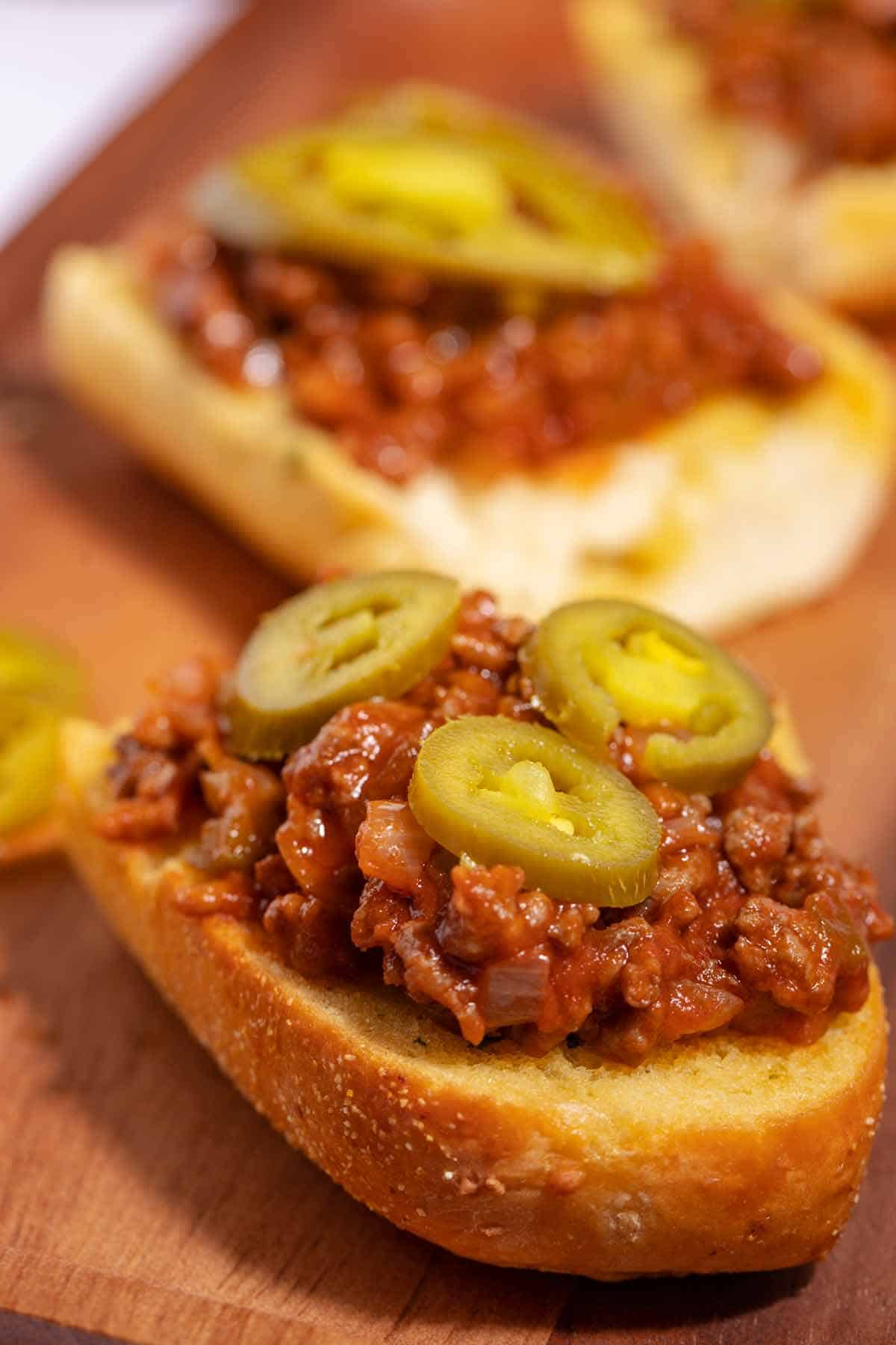 Open-faced sloppy joes sandwich on garlic bread.