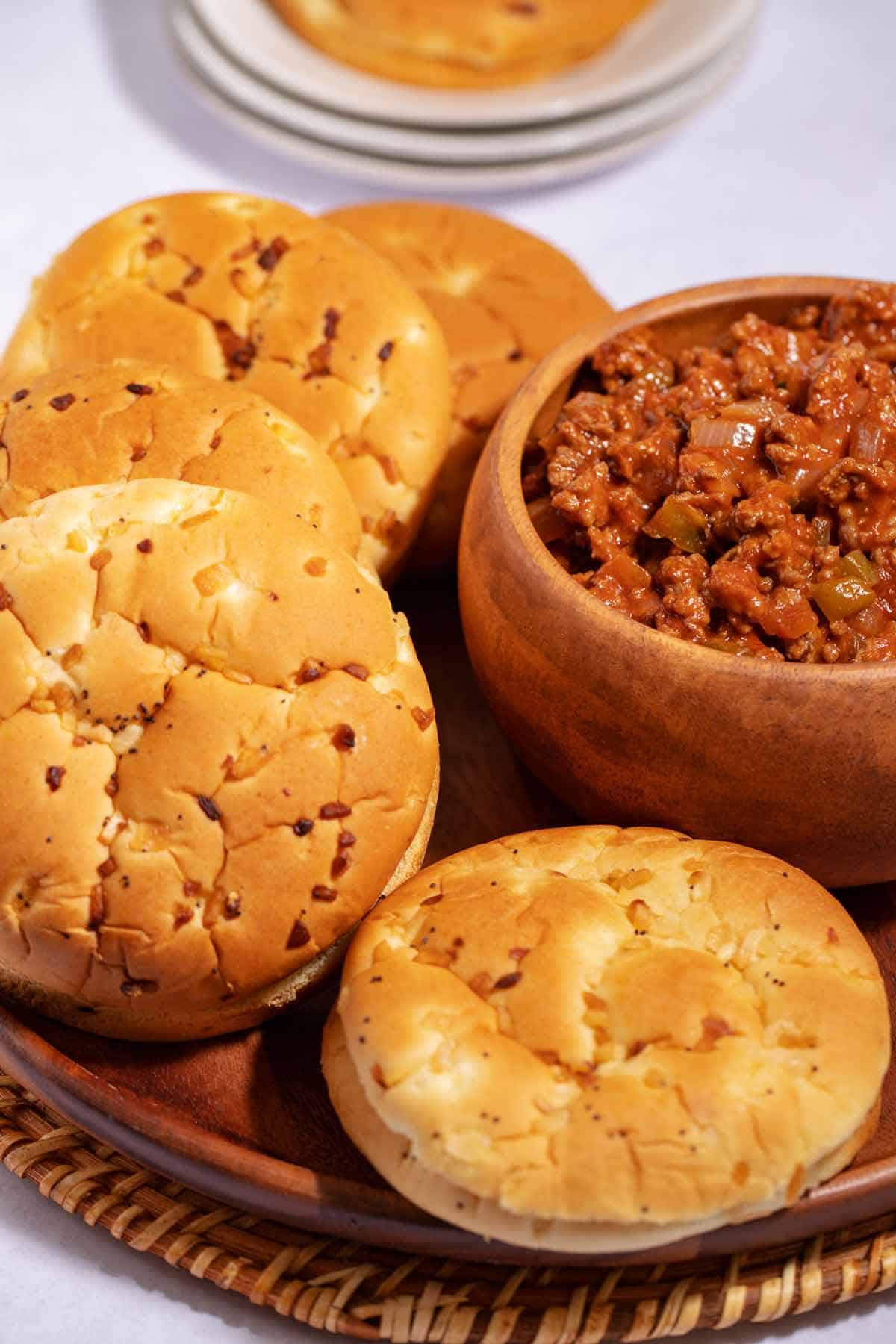 Plate of onion buns and bowl of sloppy joes.