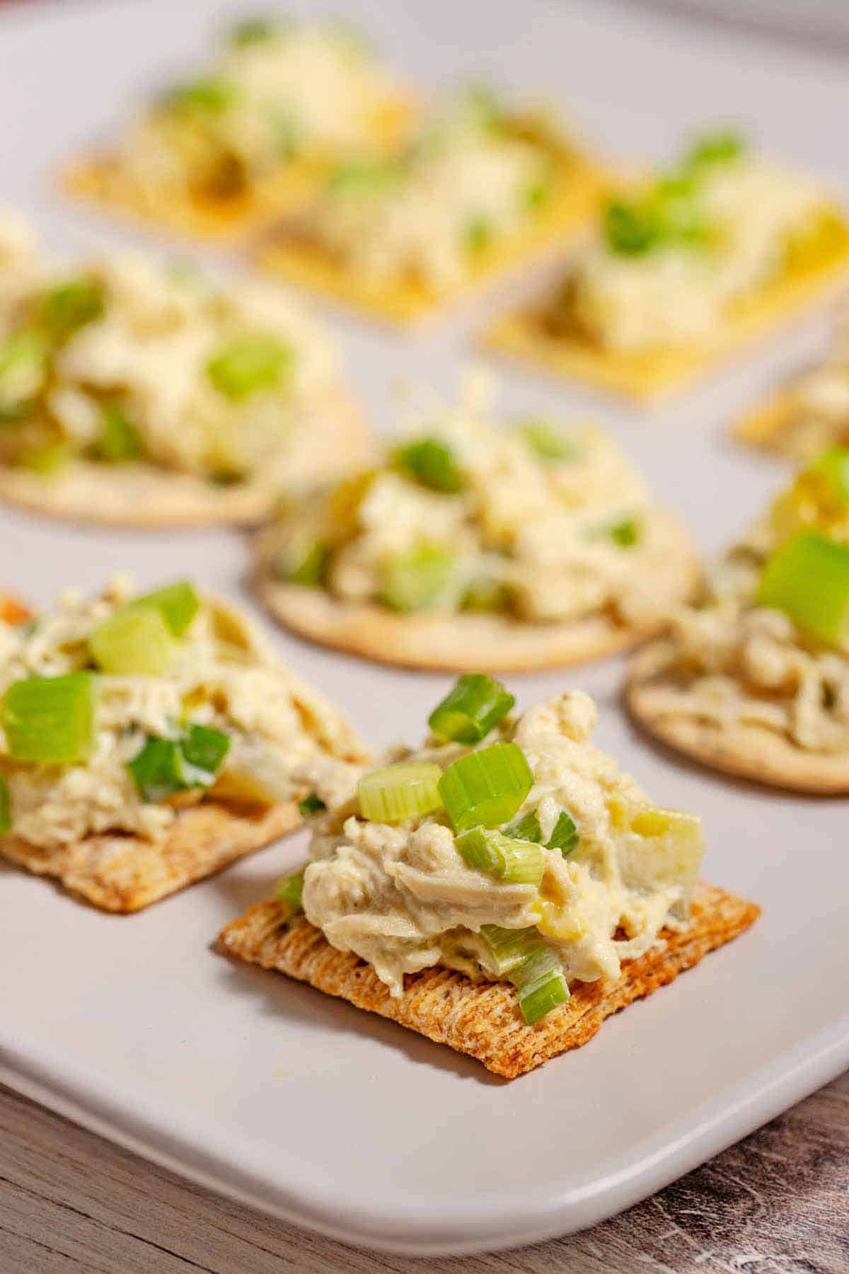 Crackers with chicken salad on a serving platter.