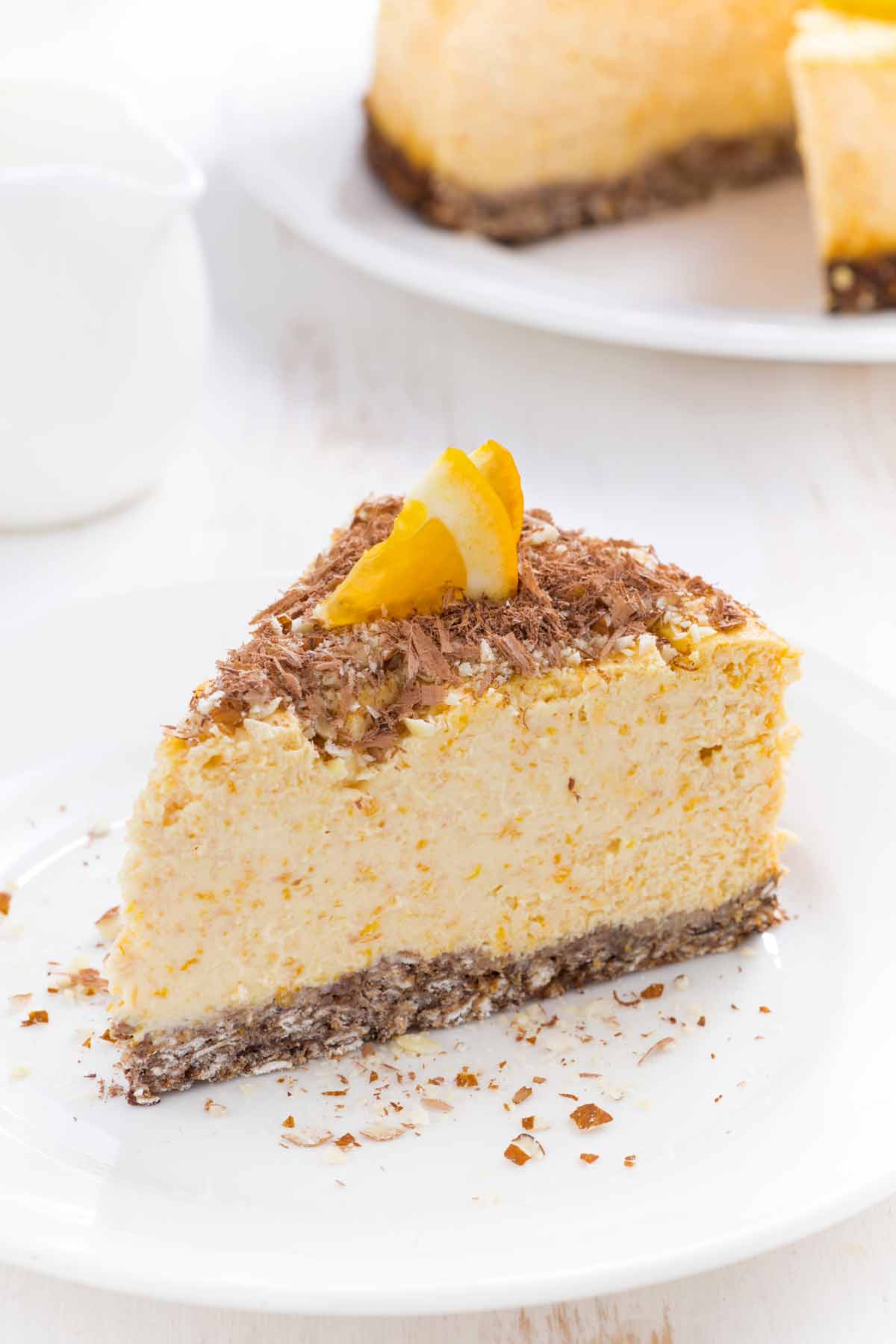 Plate with a slice of orange chocolate cheesecake.