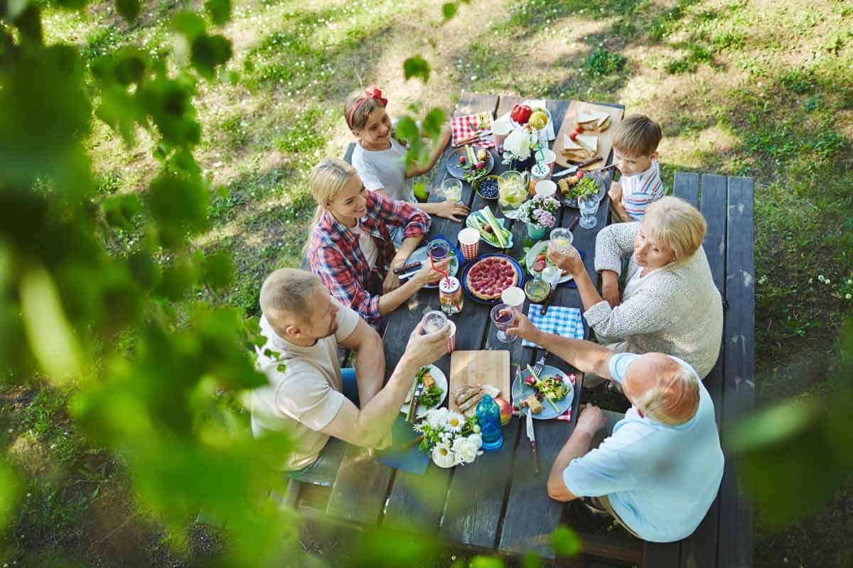 Family sitting outside at a picnic.