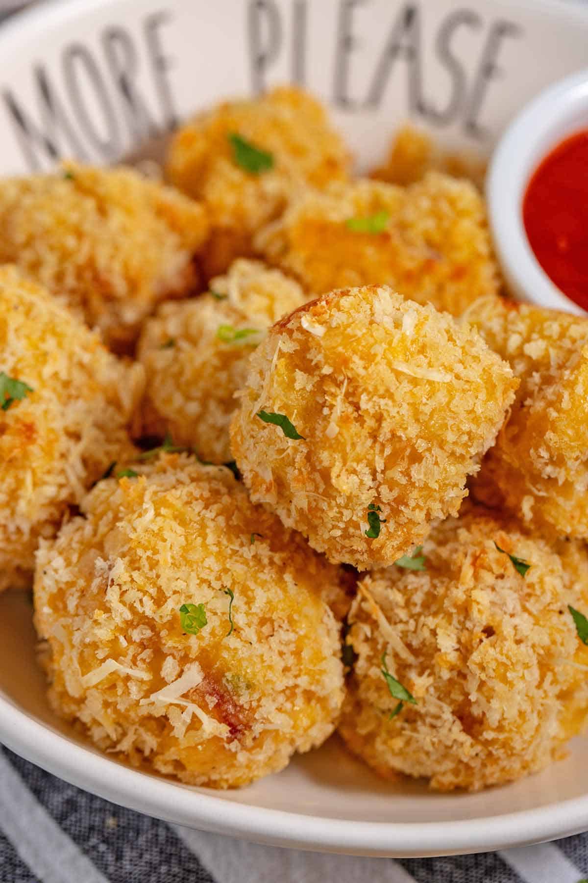 Platter of mac and cheese bites as a side dish.