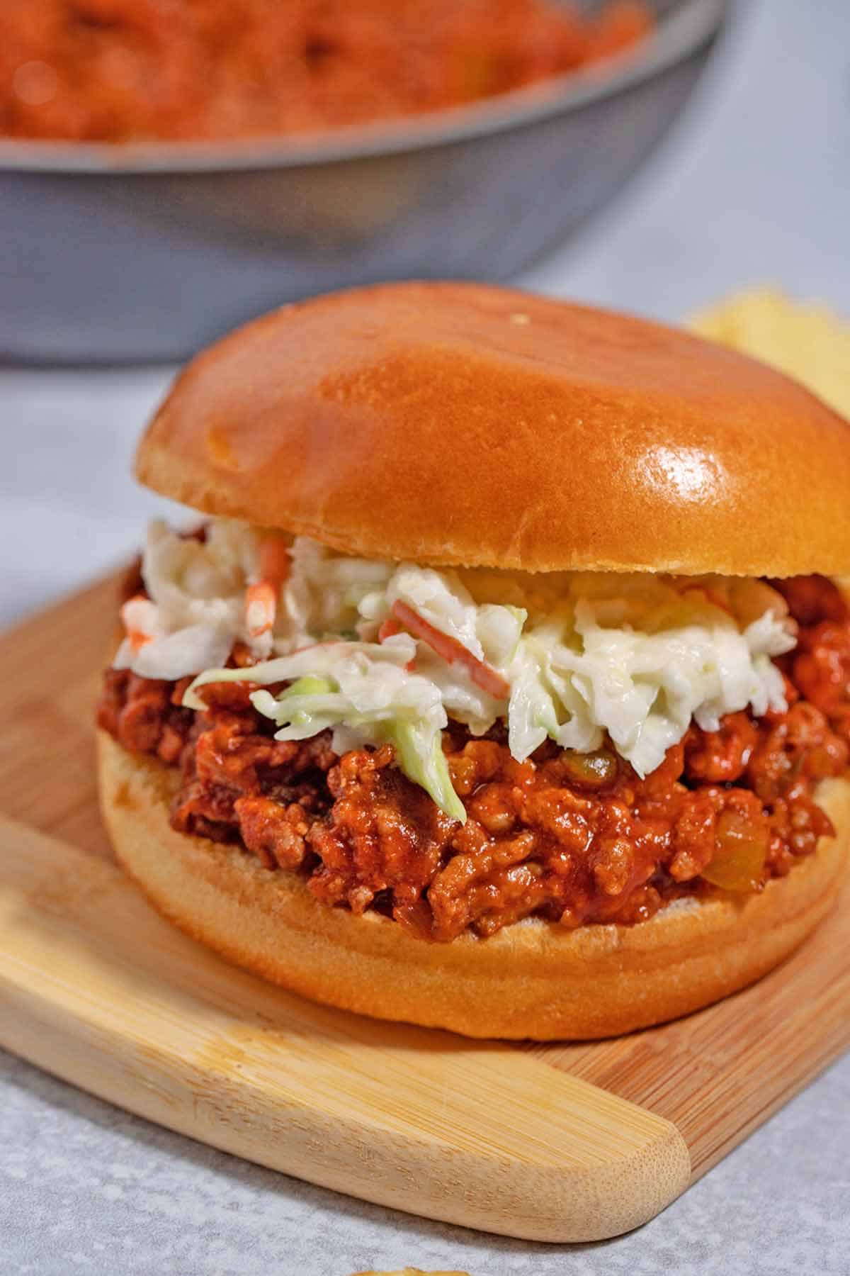 Manwich sloppy joe sandwich with coleslaw on a brioche bun.