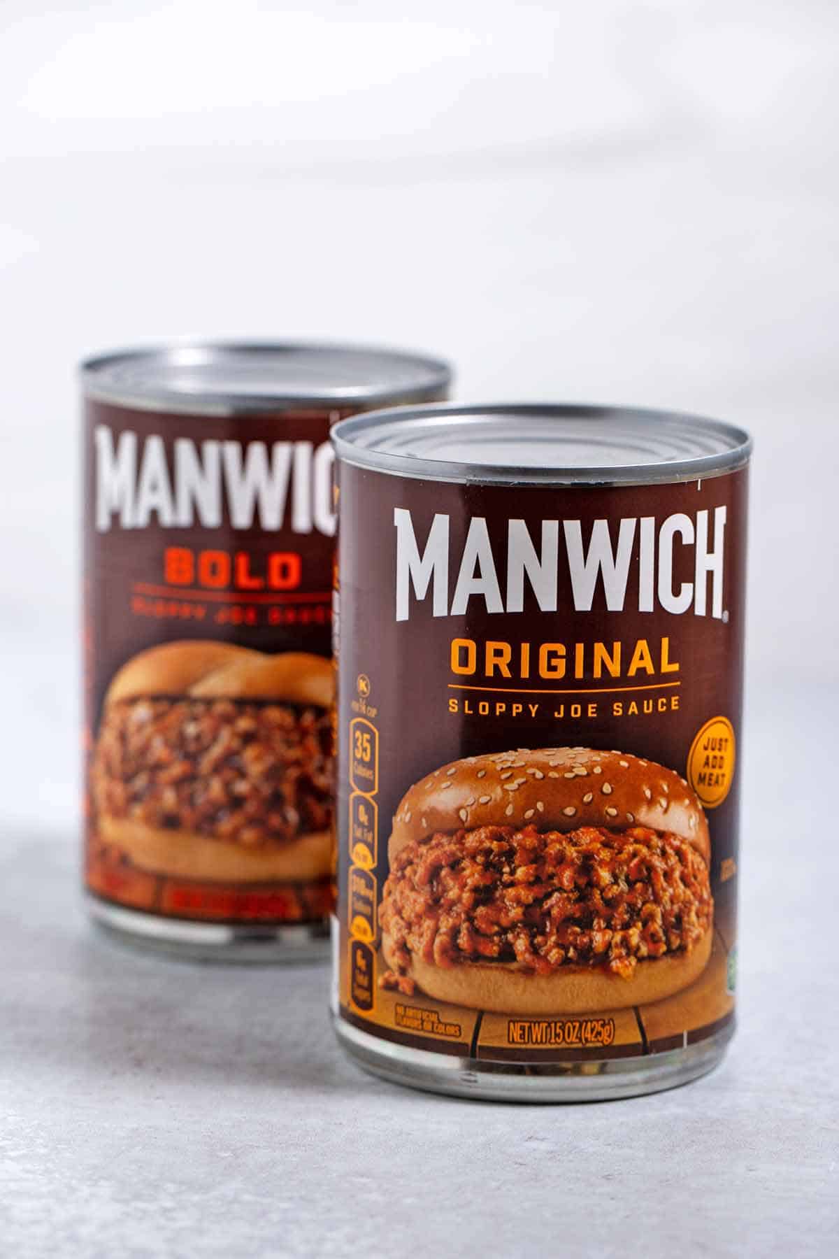 Can of original Manwich and can of bold Manwich.