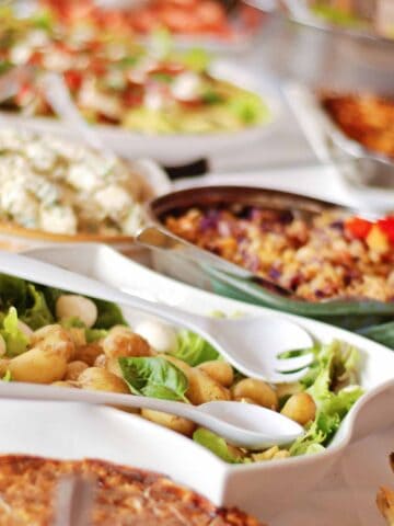 Side dishes on a buffet table to serve with chicken salad.