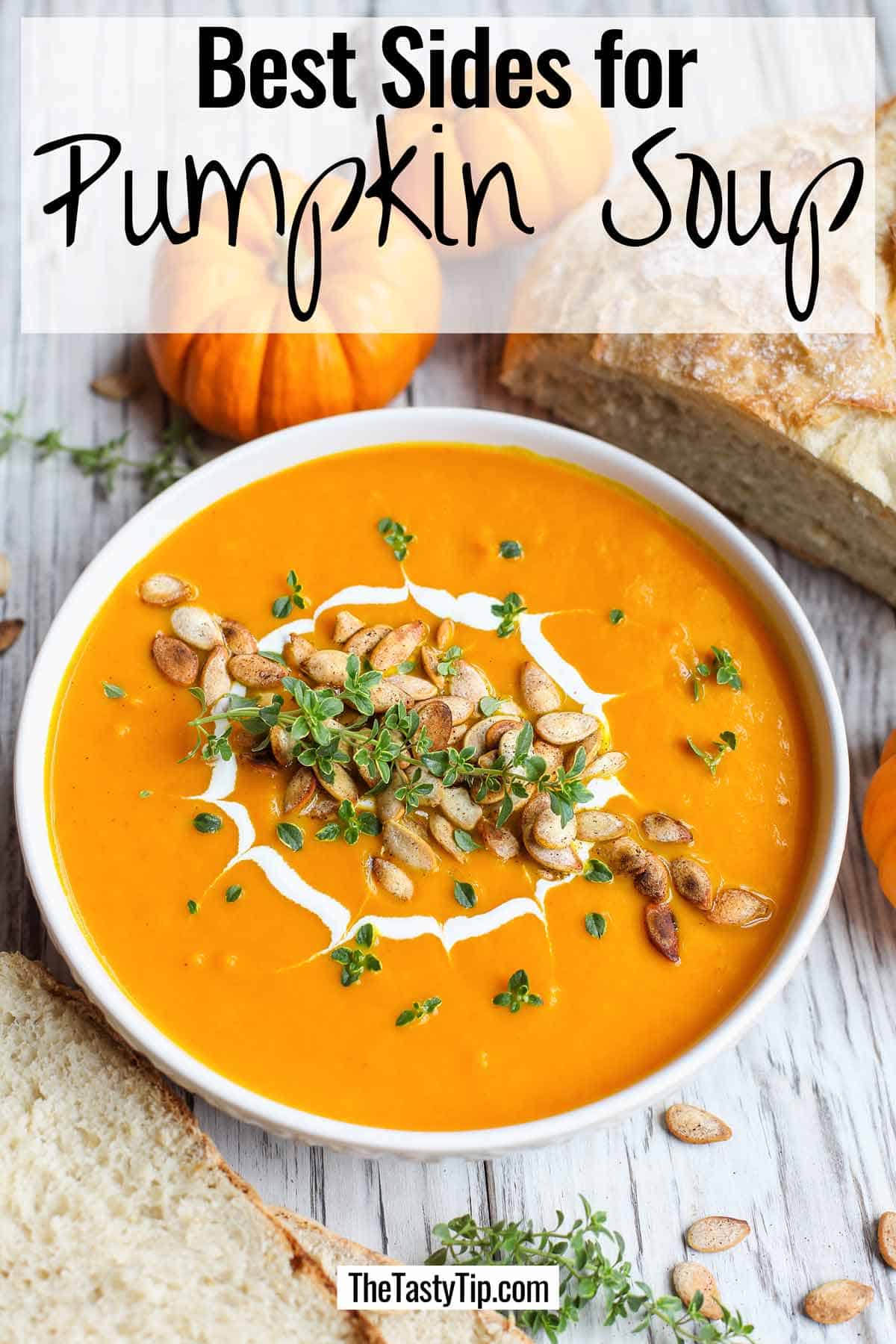 Bowl of pumpkin soup garnished with greens and roasted pumpkin seeds. Crusty bread and small decorative pumpkins in the background. Overlay with words "Best sides for pumpkin soup".
