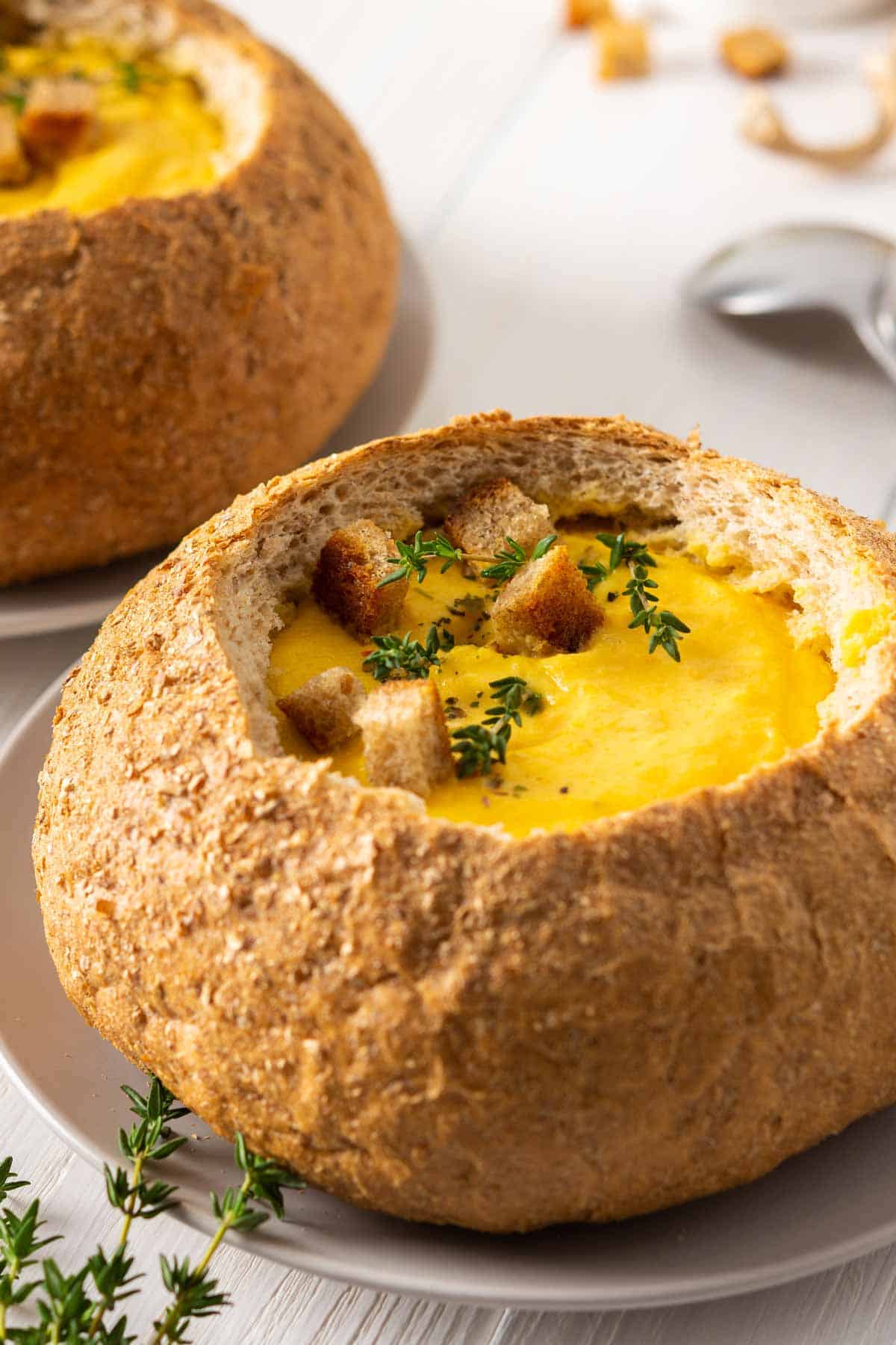 Bread bowl filled with butternut squash soup.