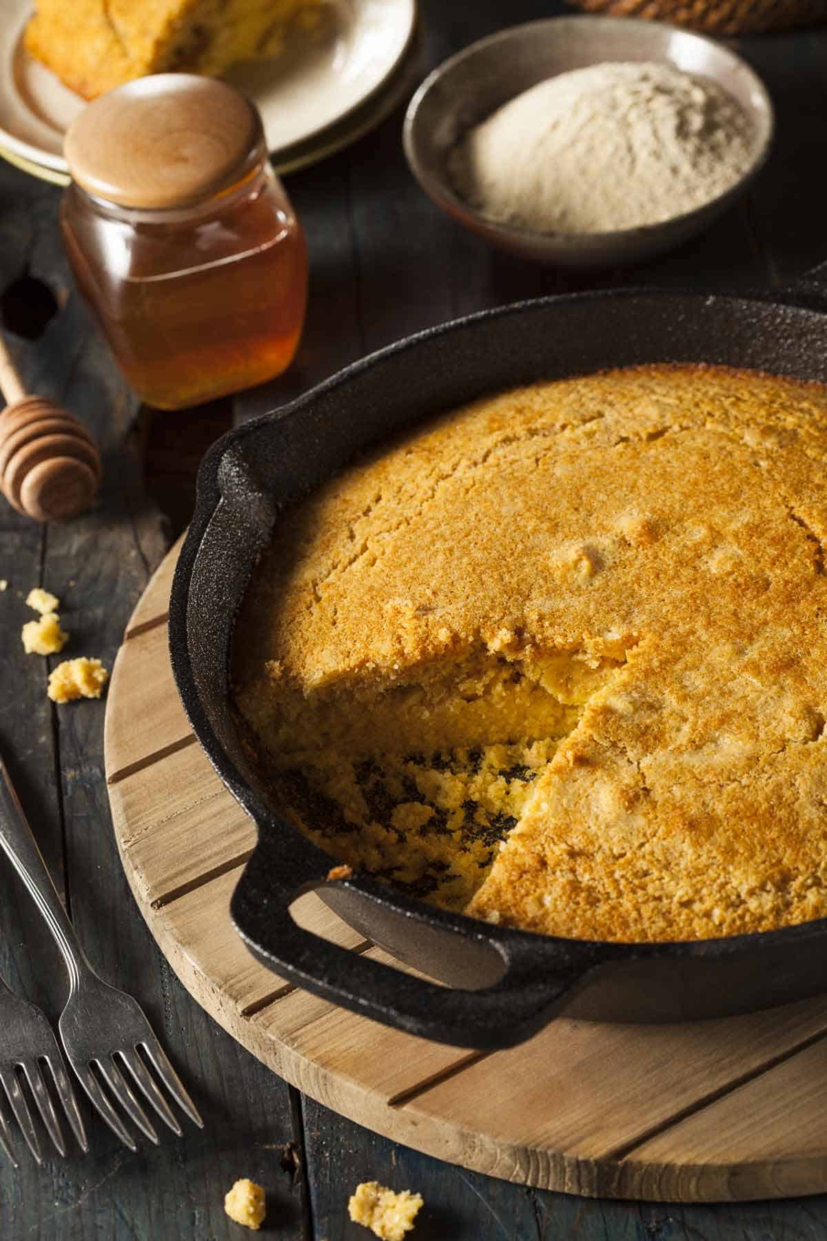 Pan of cornbread with honey