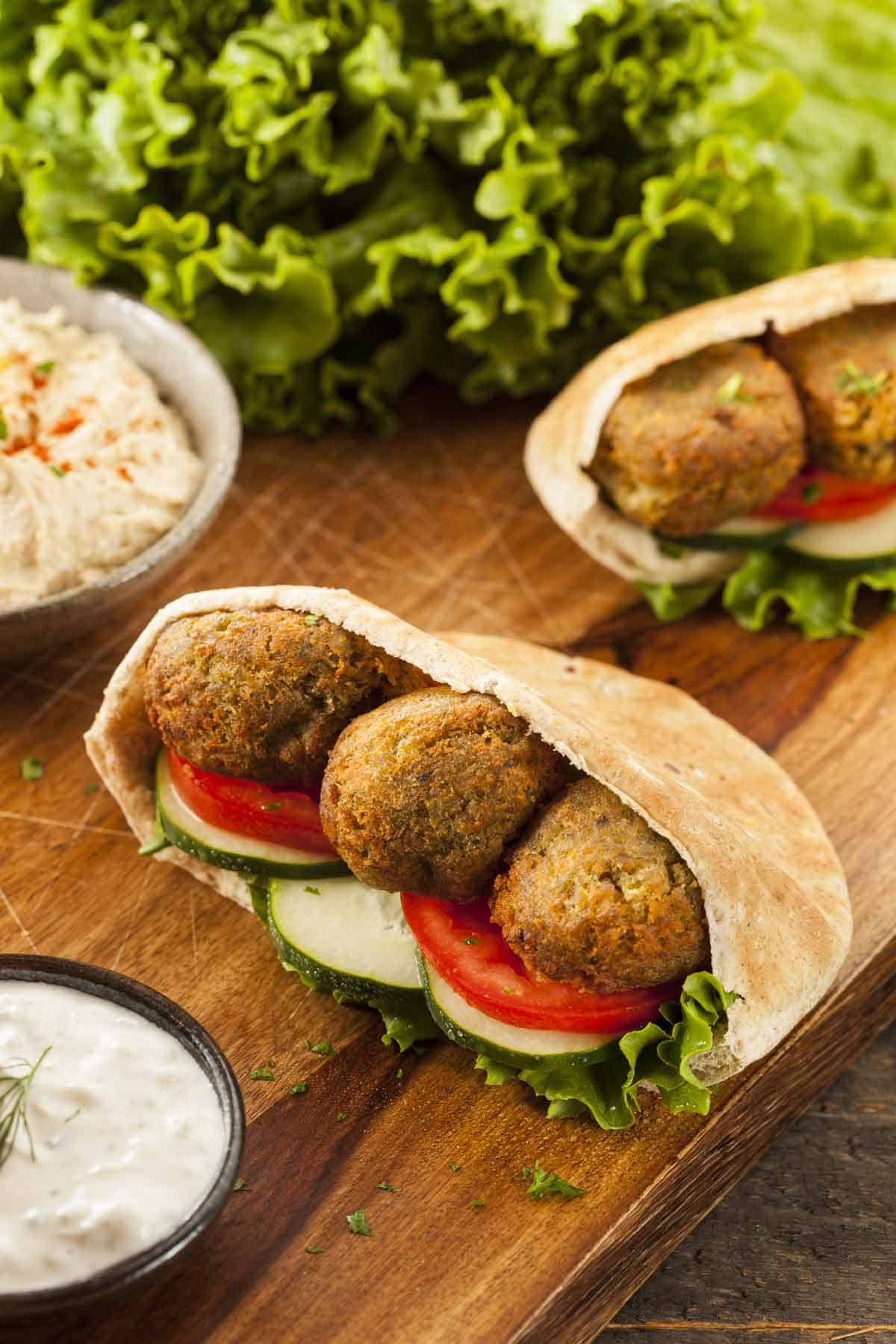 Falafel pita sandwich on a sandwich board.