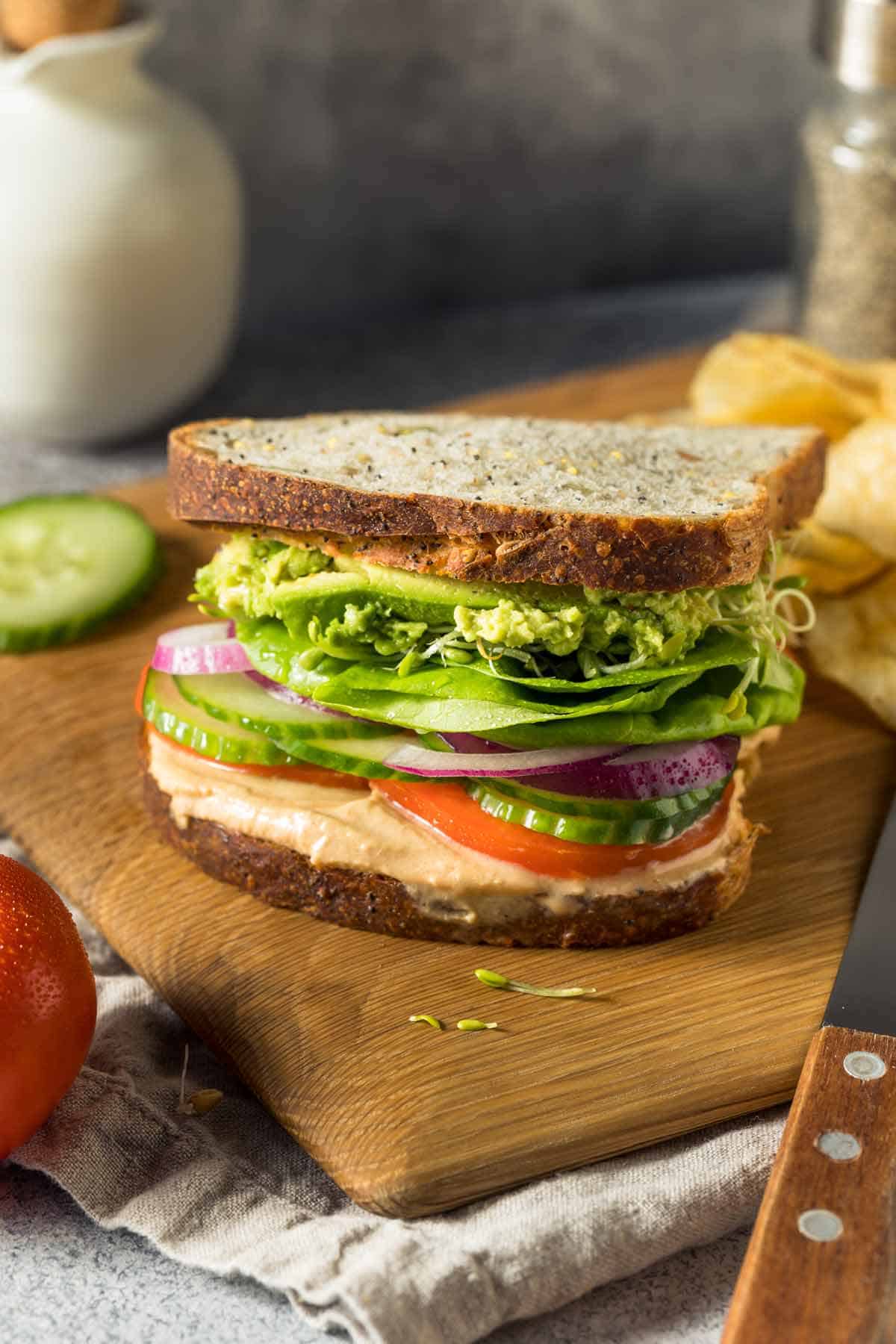 Mediterranean sandwich on a cutting board.